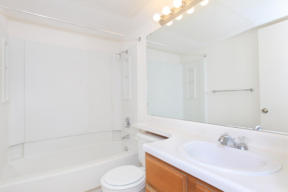 a large white tub sitting next to a sink