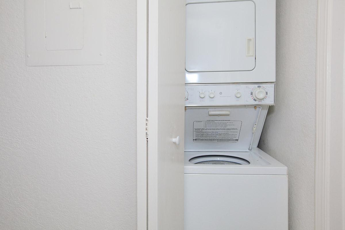 a white microwave oven sitting on top of a refrigerator