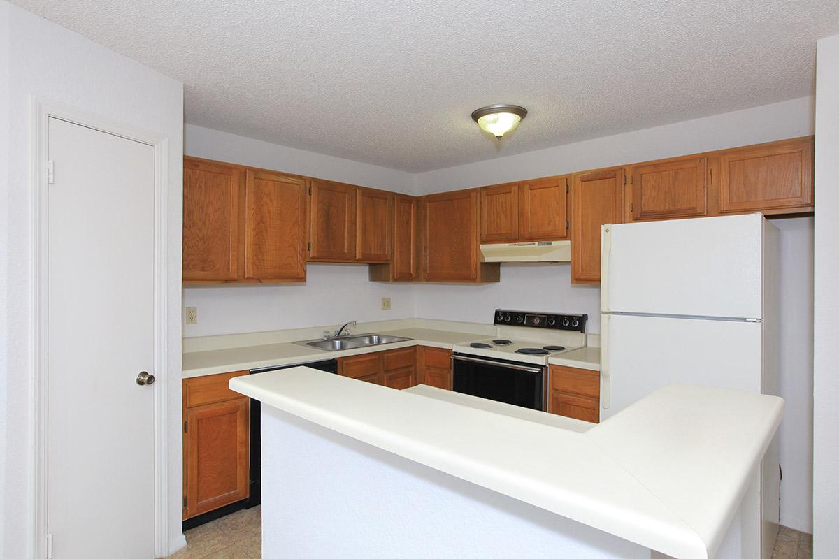 a kitchen with a stove and a refrigerator