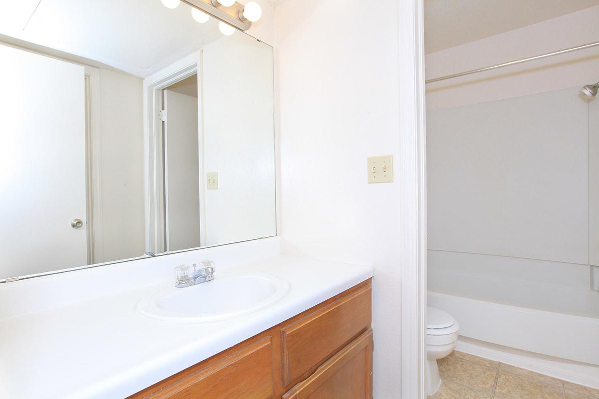 a large white tub sitting next to a sink