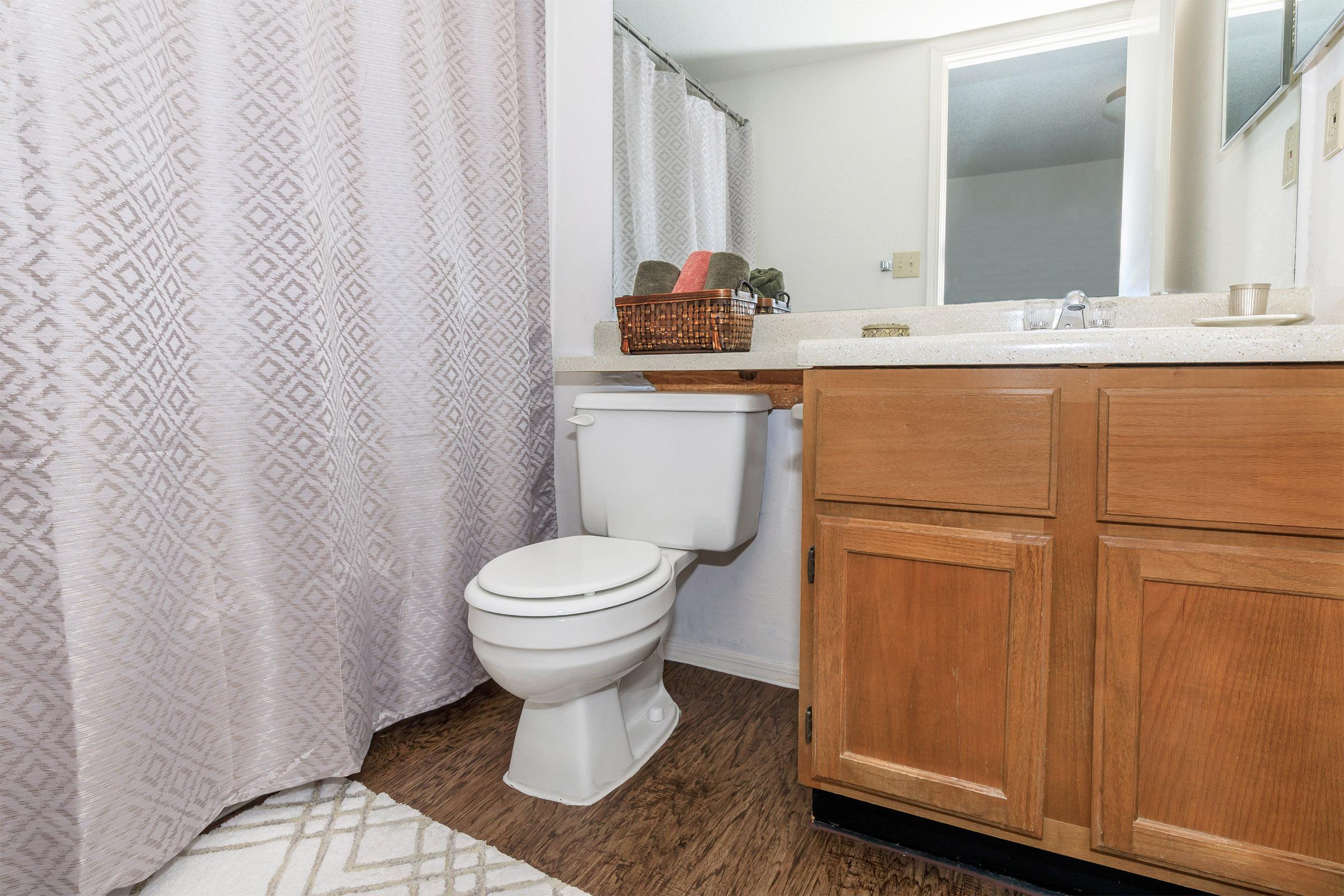 a white tub sitting next to a shower curtain