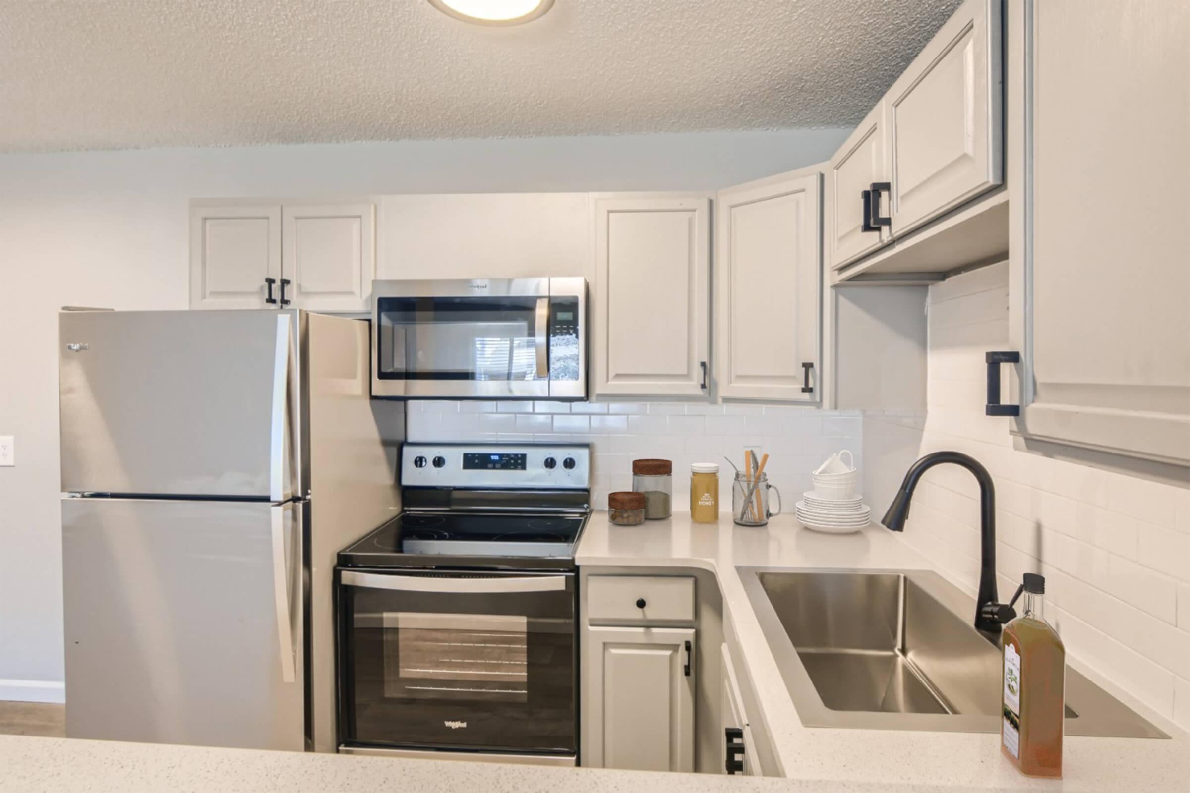 a kitchen with a sink and a microwave