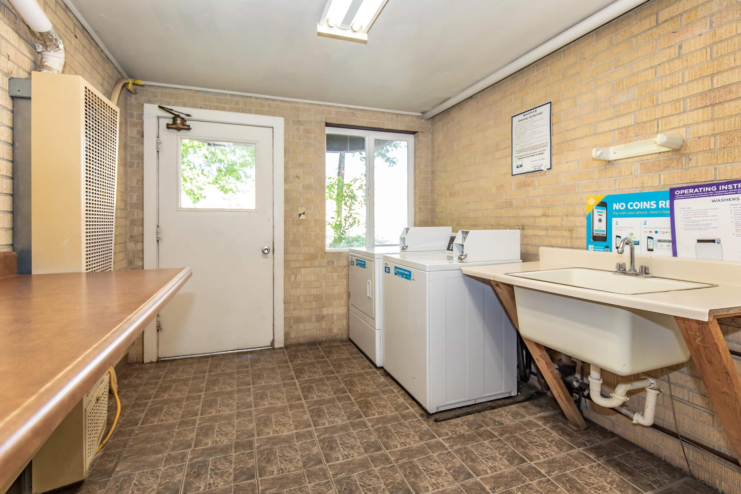 a kitchen with a table in front of a window