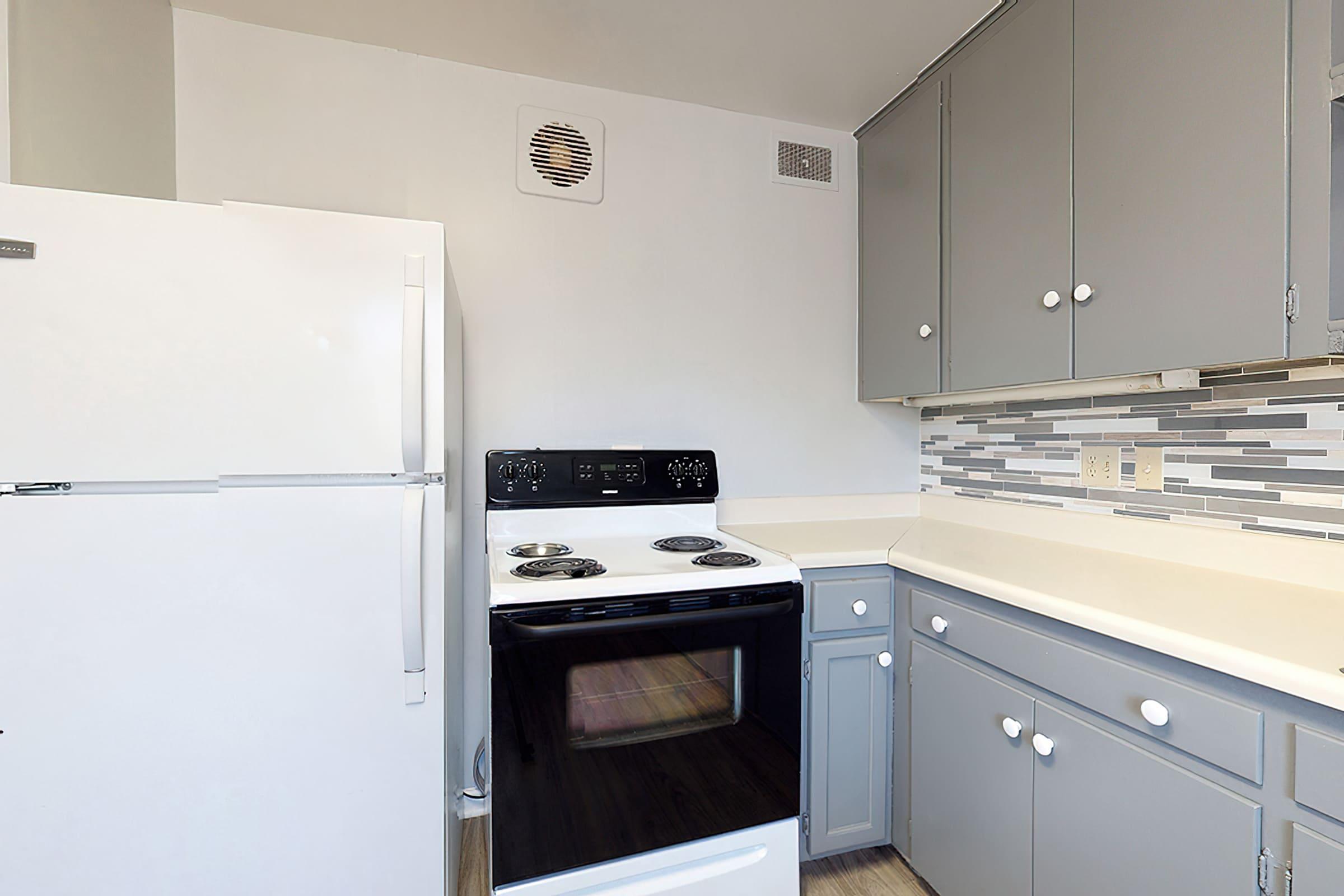 a kitchen with a stove and a refrigerator