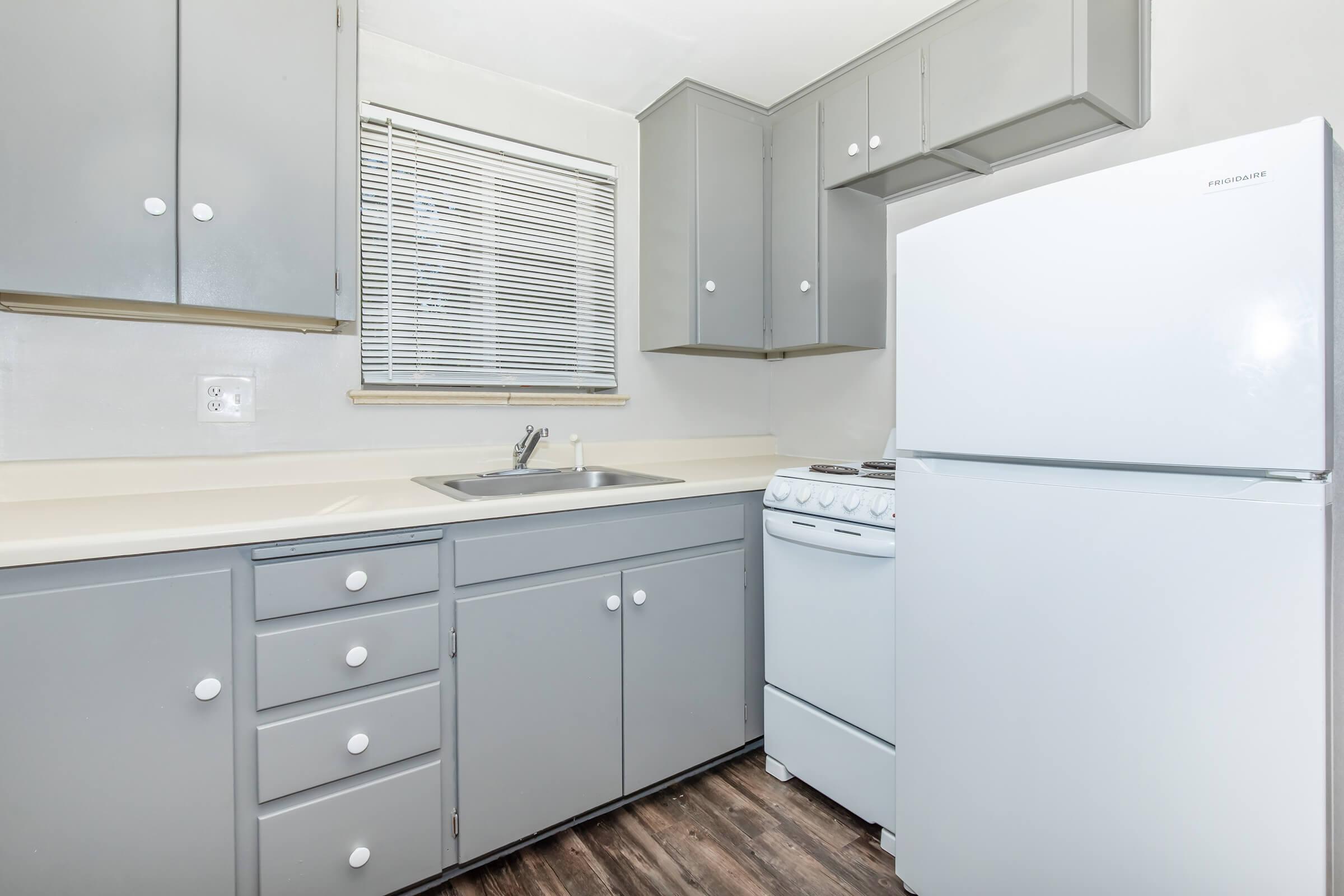 a kitchen with a stove and a refrigerator