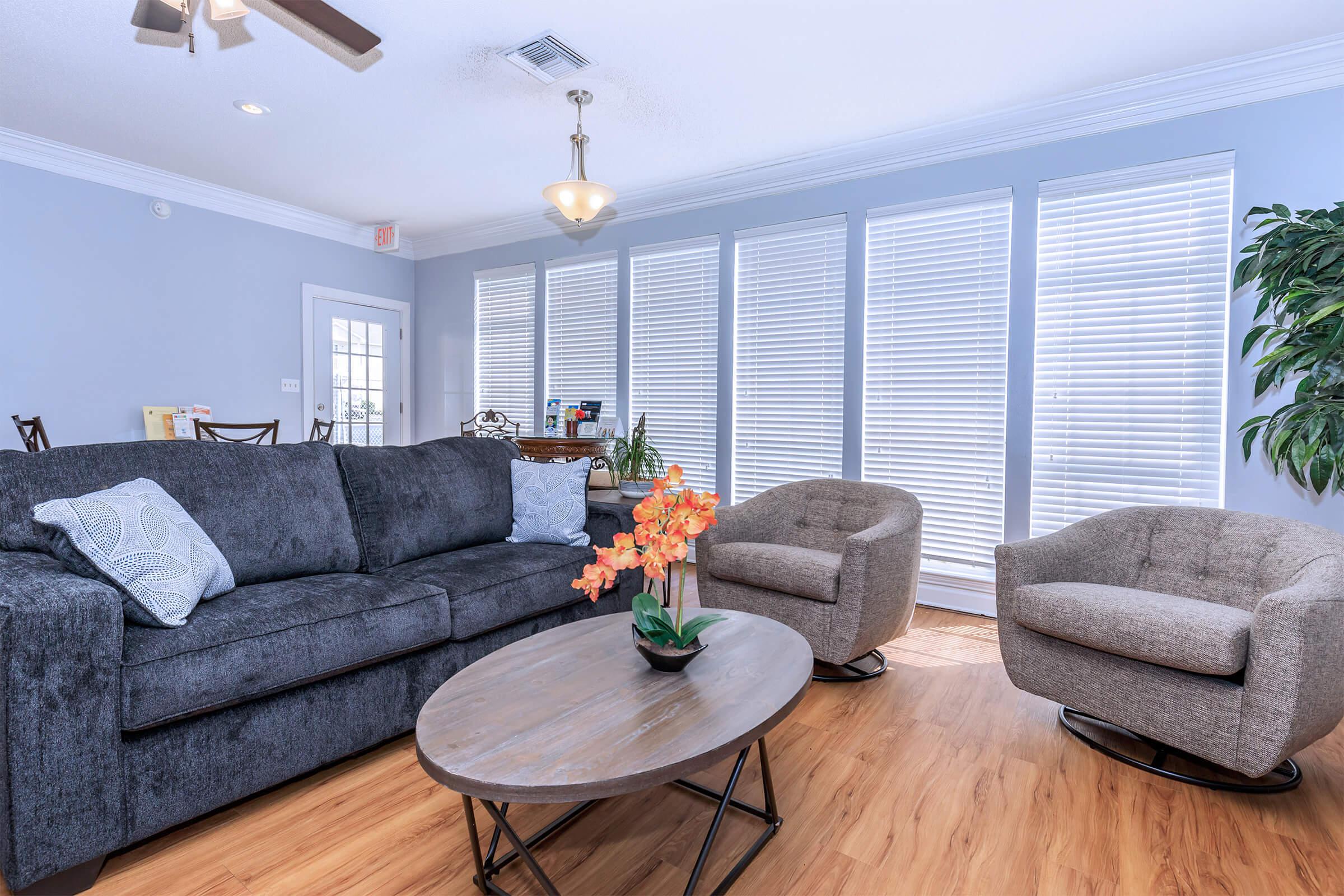 a living room filled with furniture and a large window