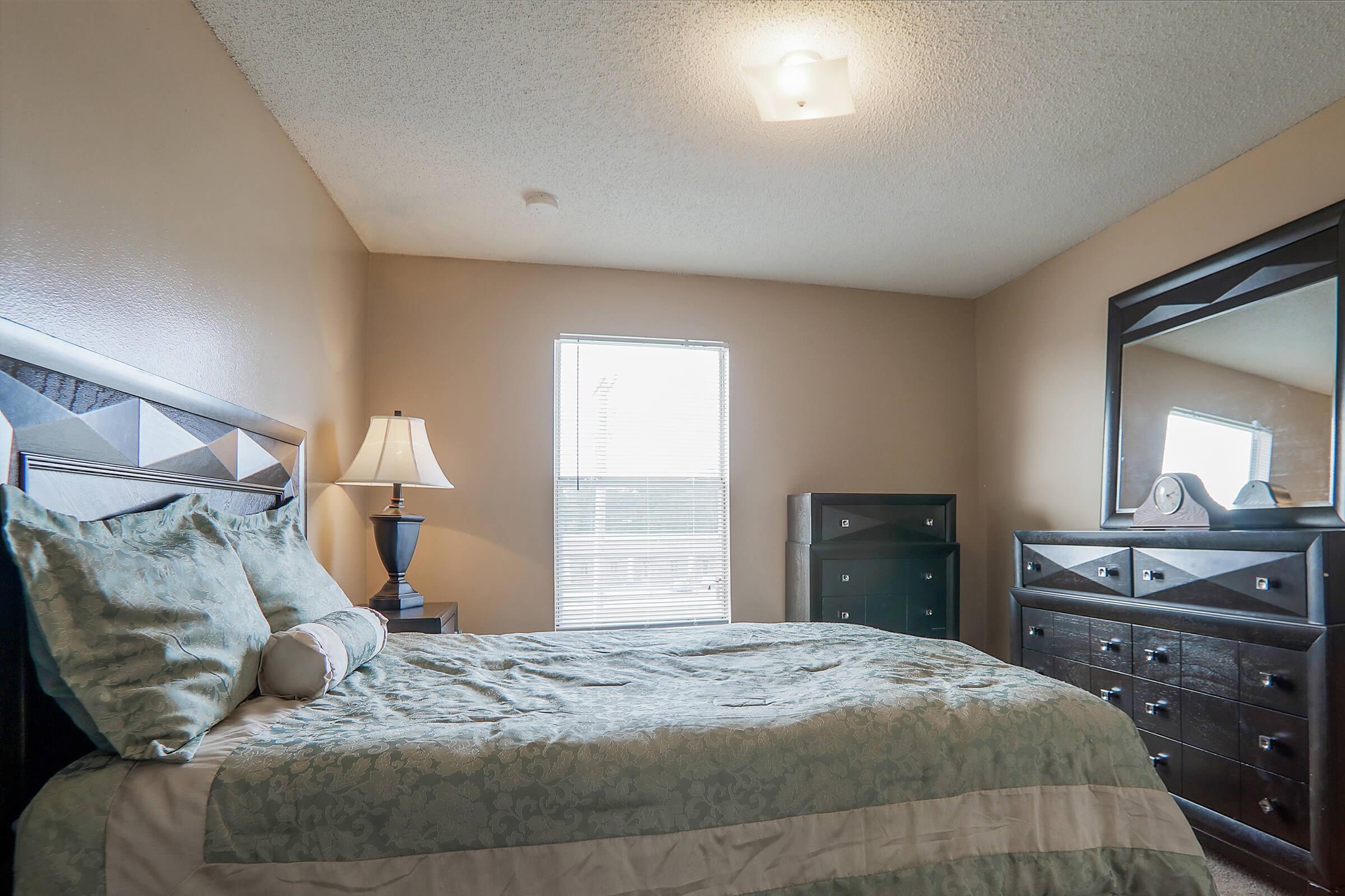 a bedroom with a large bed in a hotel room