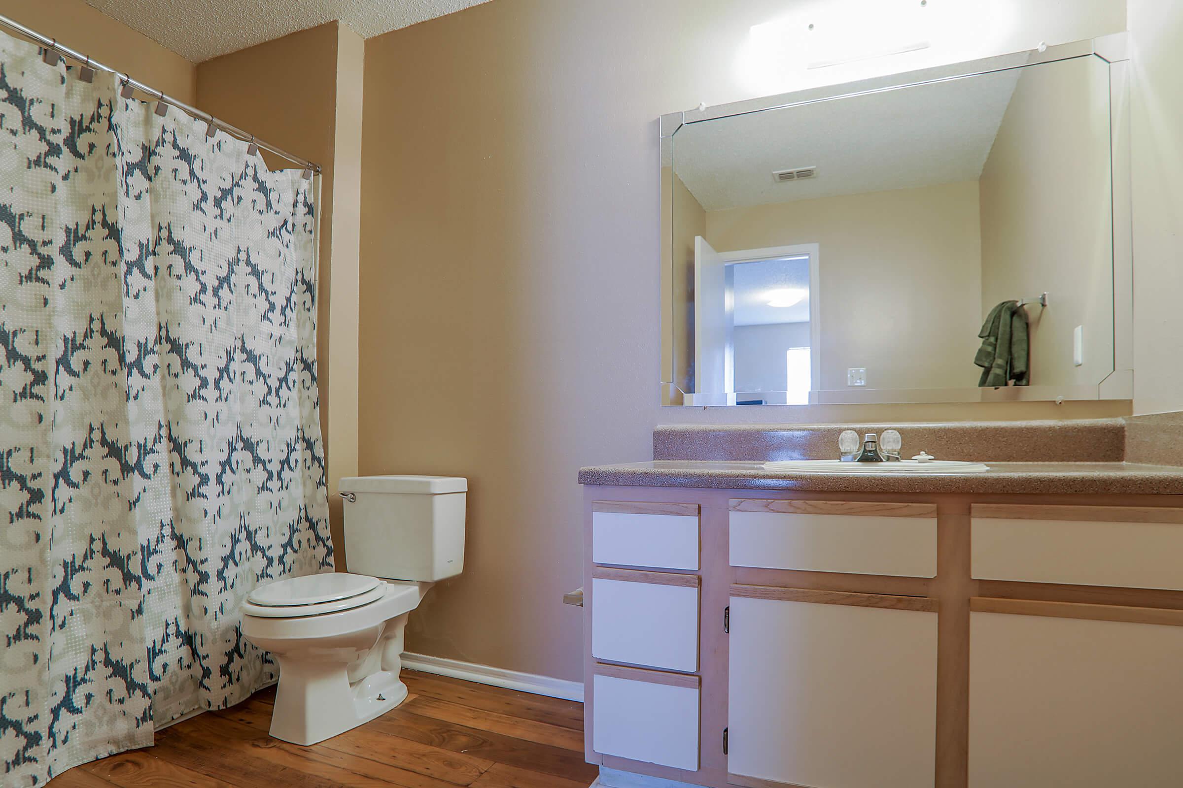 a white tub sitting next to a shower curtain