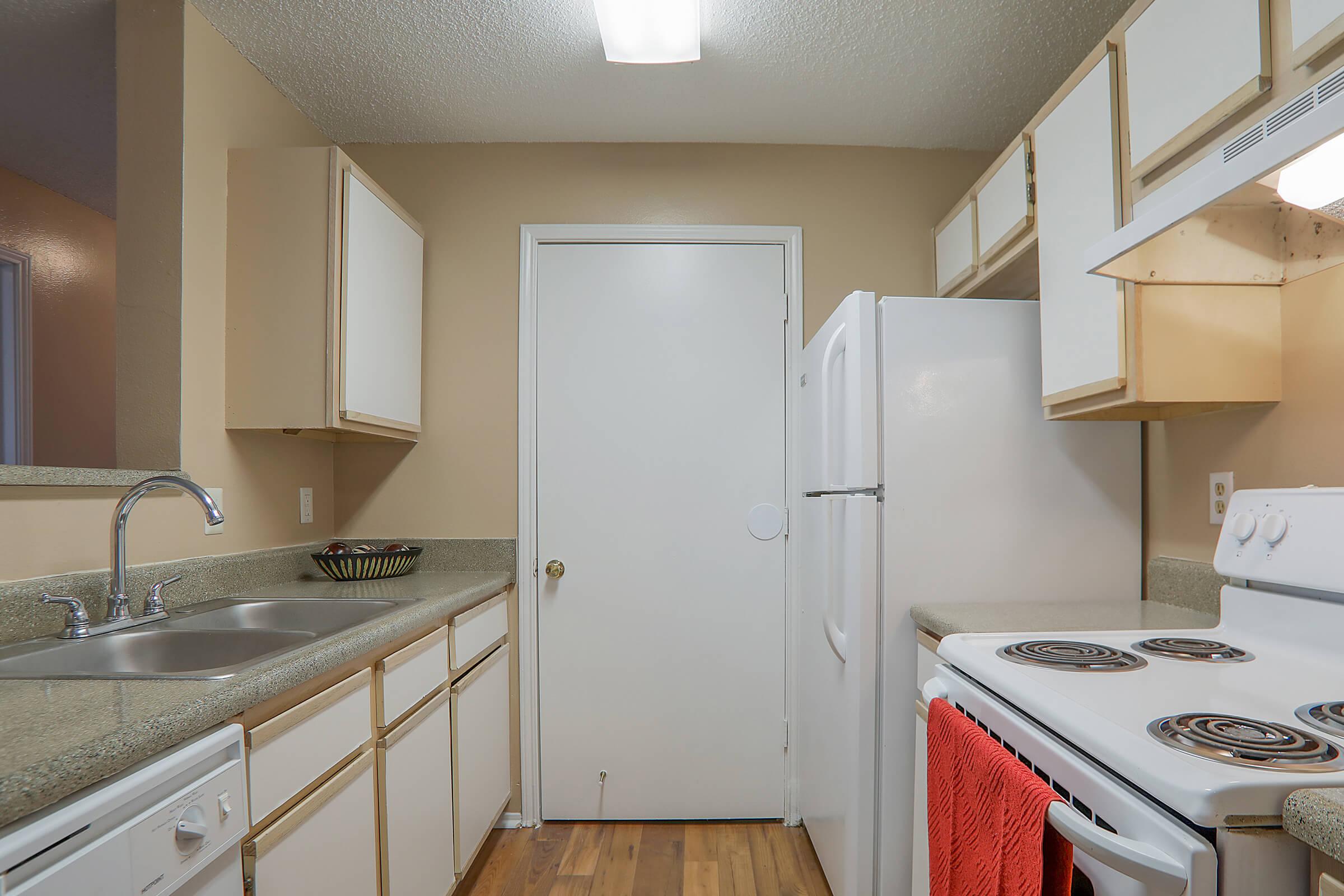 a kitchen with a sink and a mirror