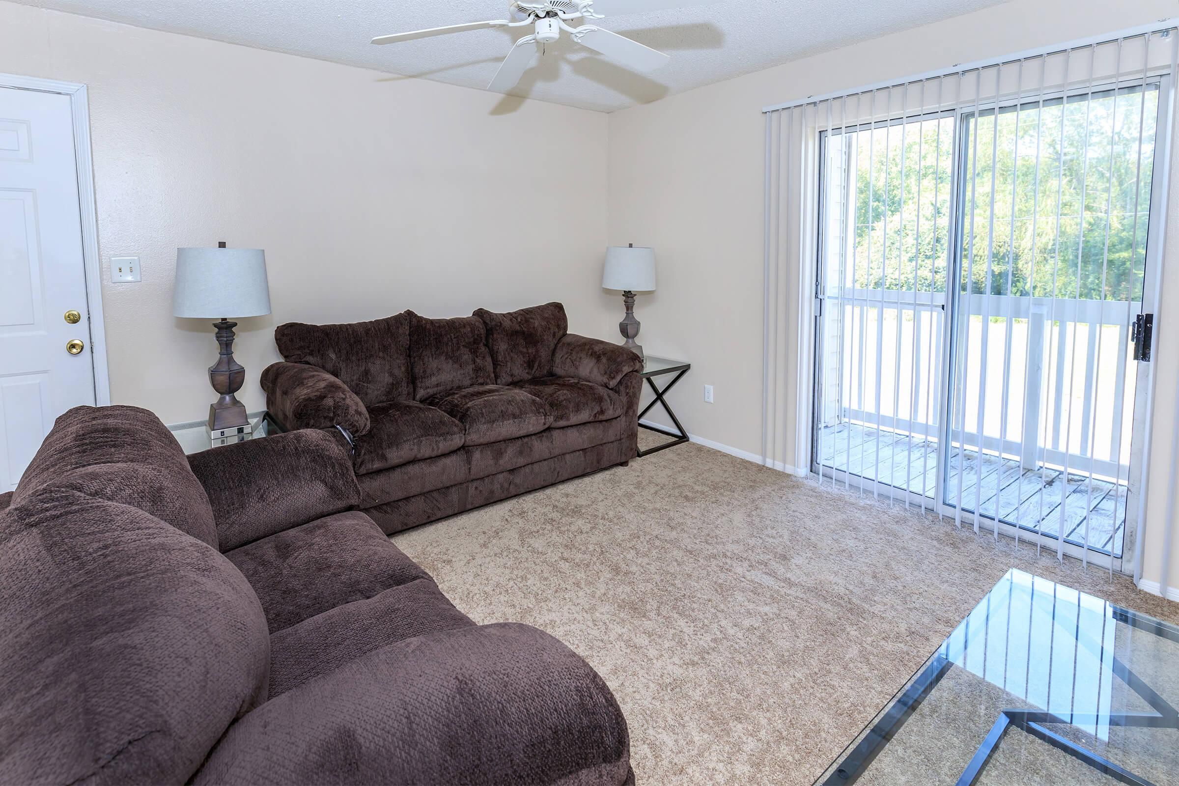 a living room filled with furniture and a large window