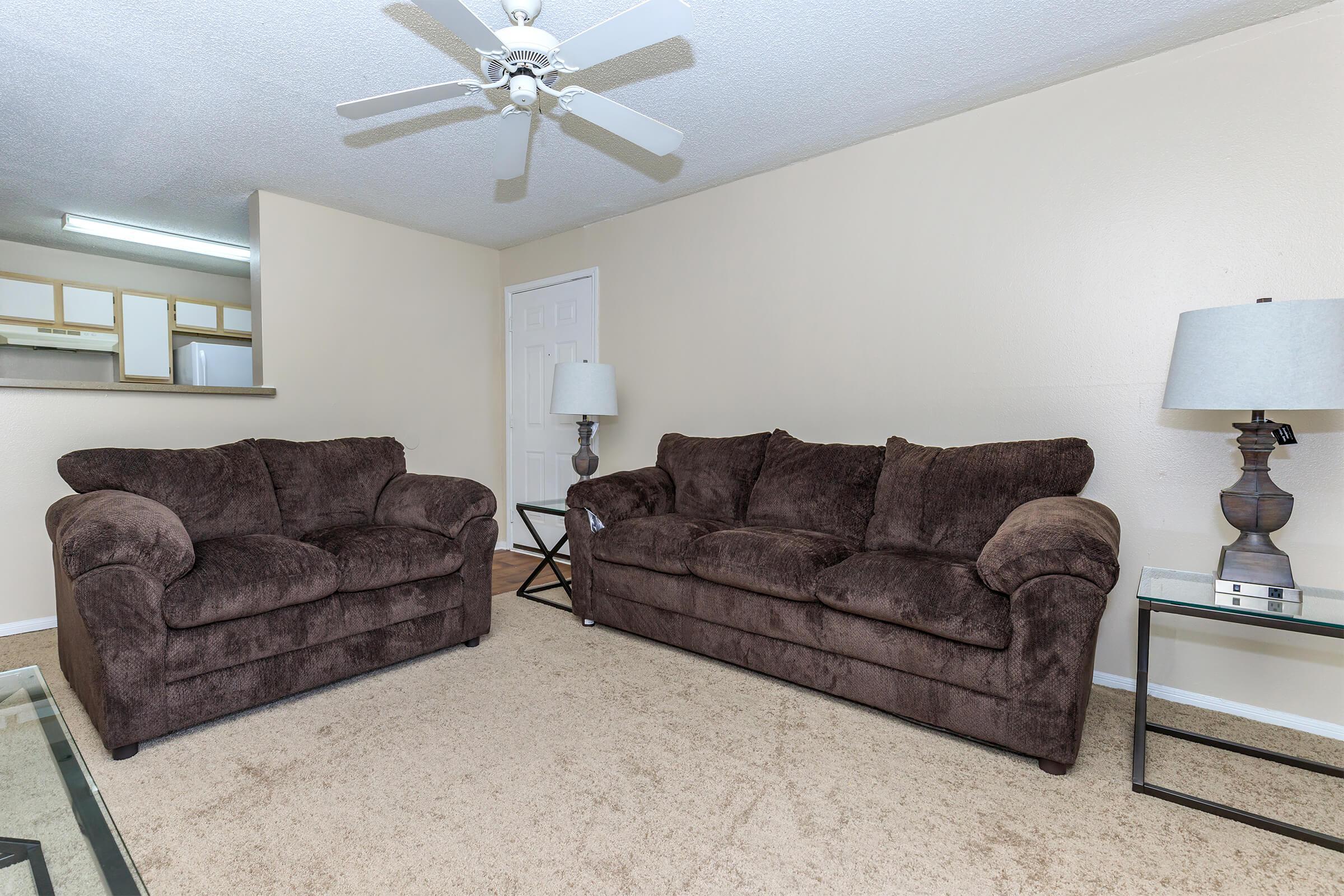 a living room filled with furniture and a flat screen tv