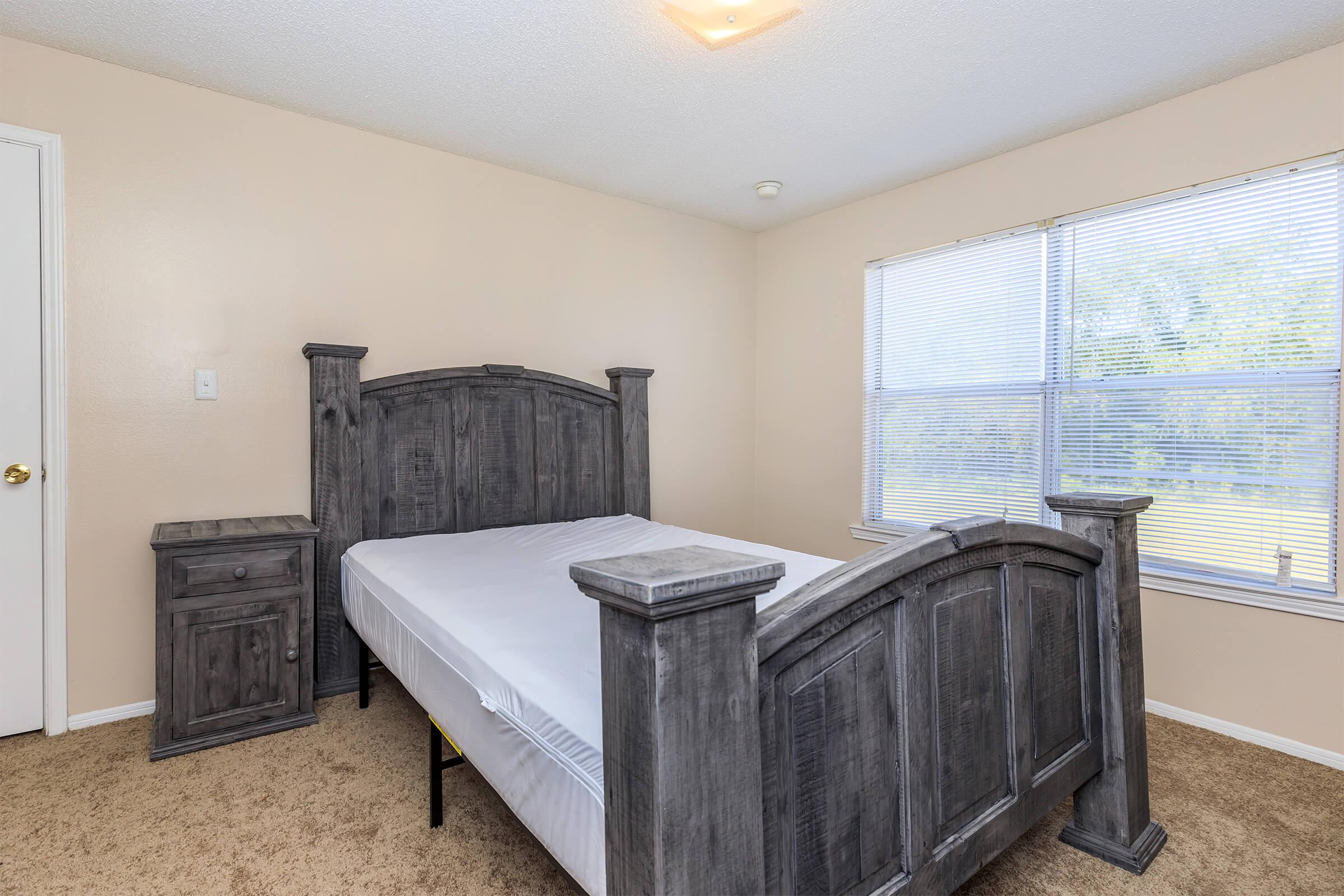 a bedroom with a bed and window in a room