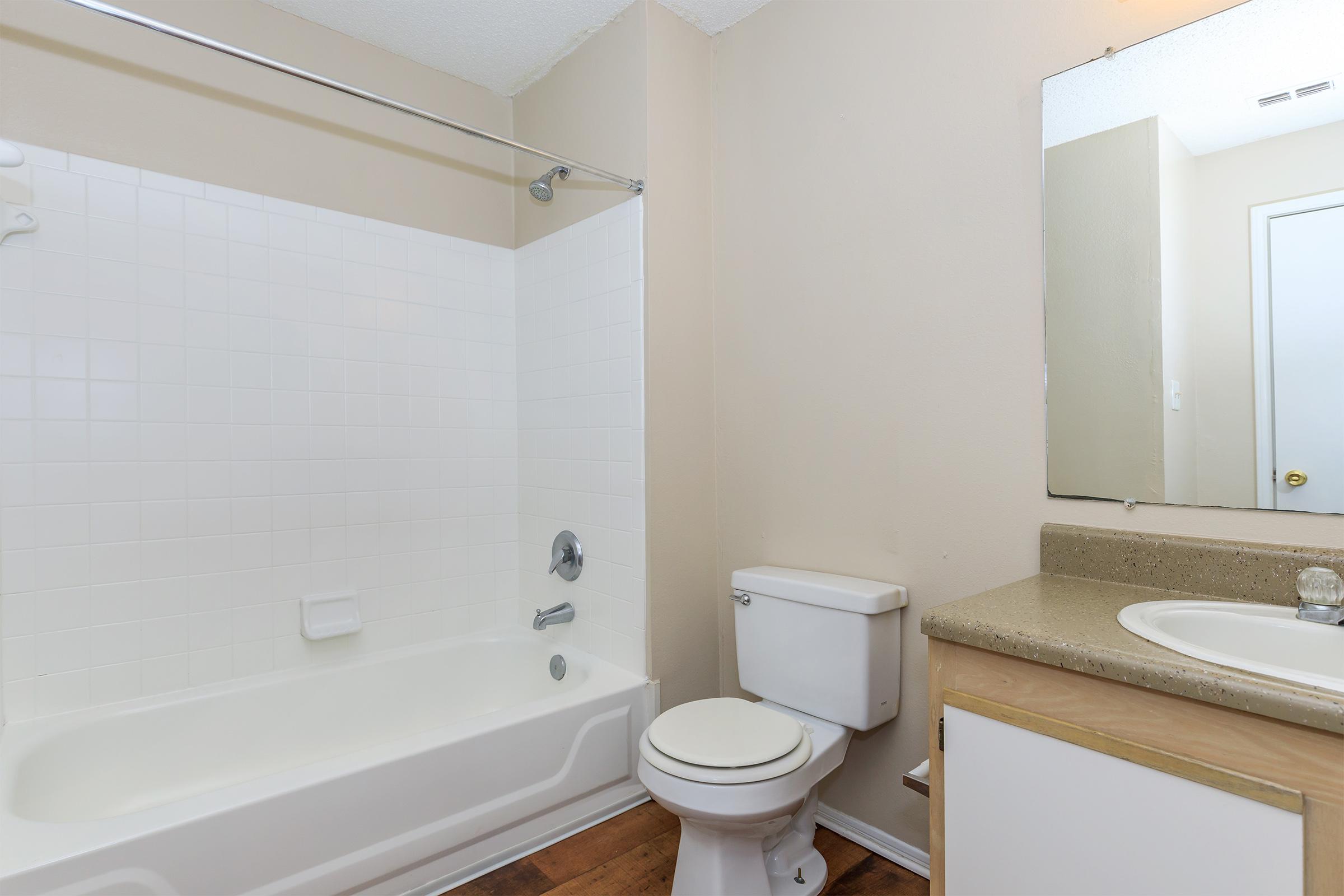 a white tub sitting next to a sink