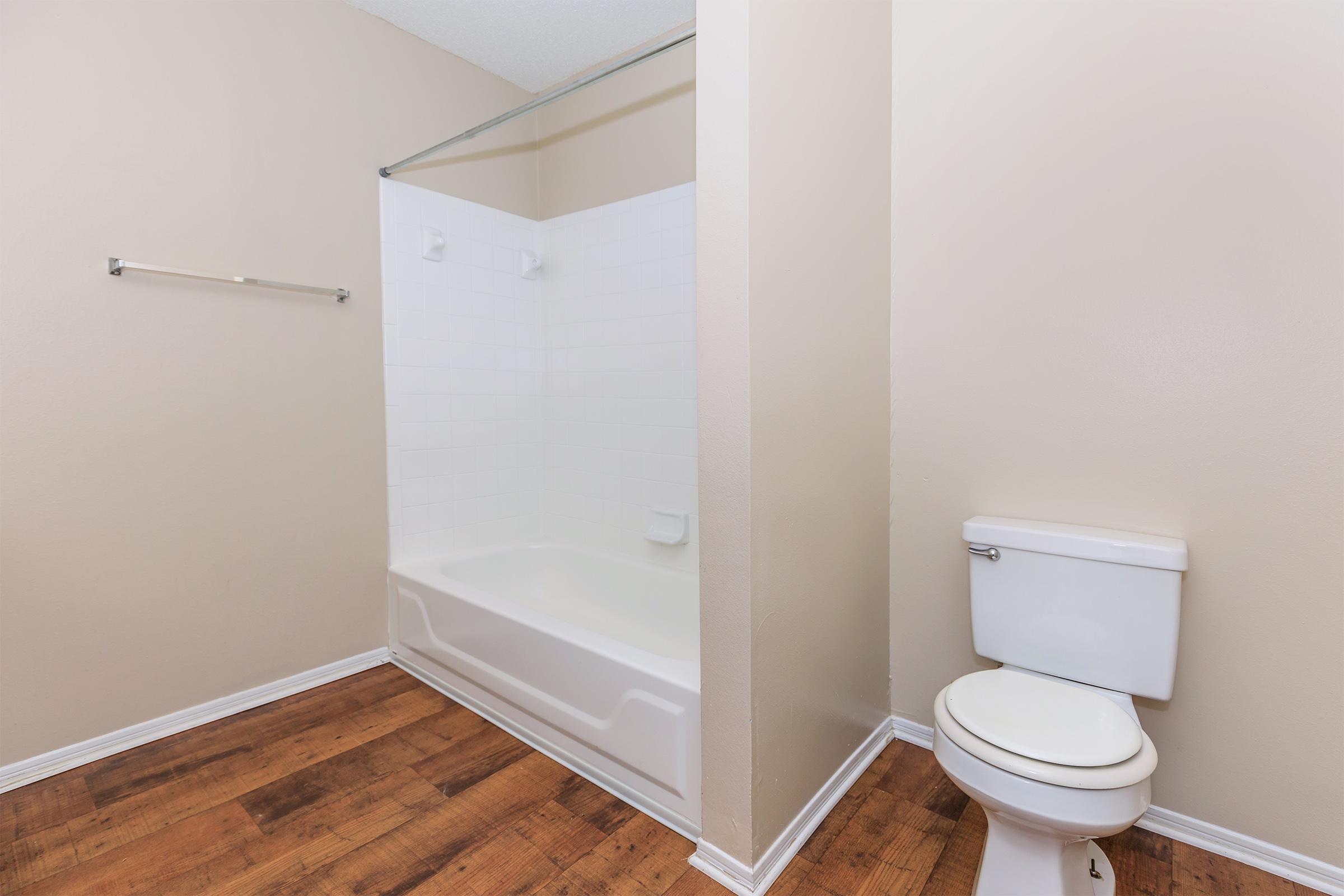 a white tub sitting next to a shower