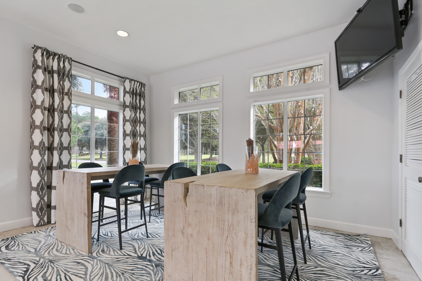 a living room filled with furniture and a large window