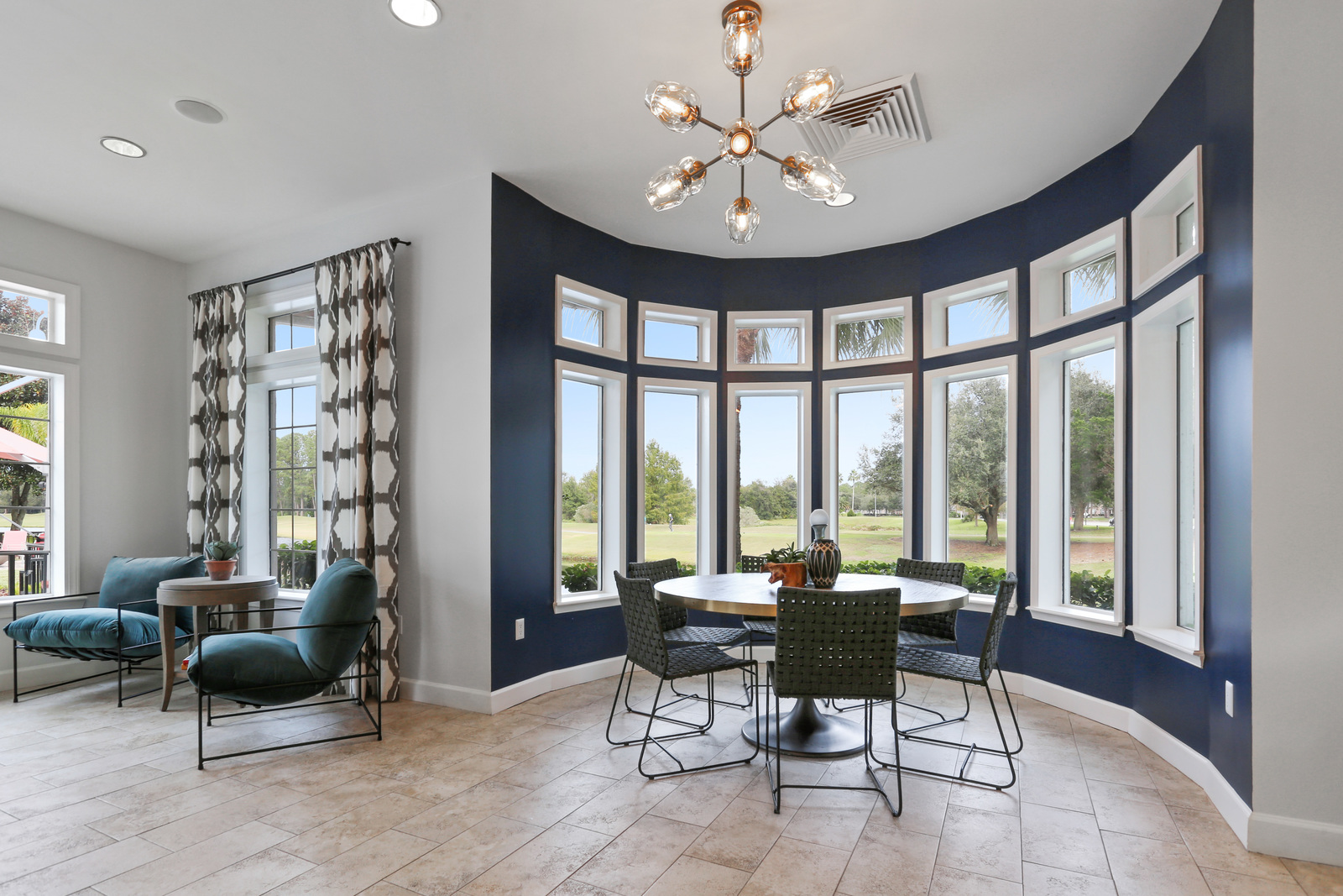 a living room filled with furniture and a large window