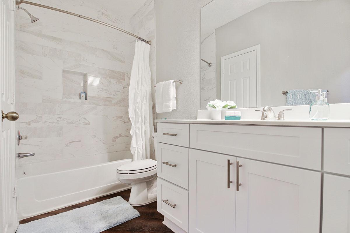 a large white tub sitting next to a sink