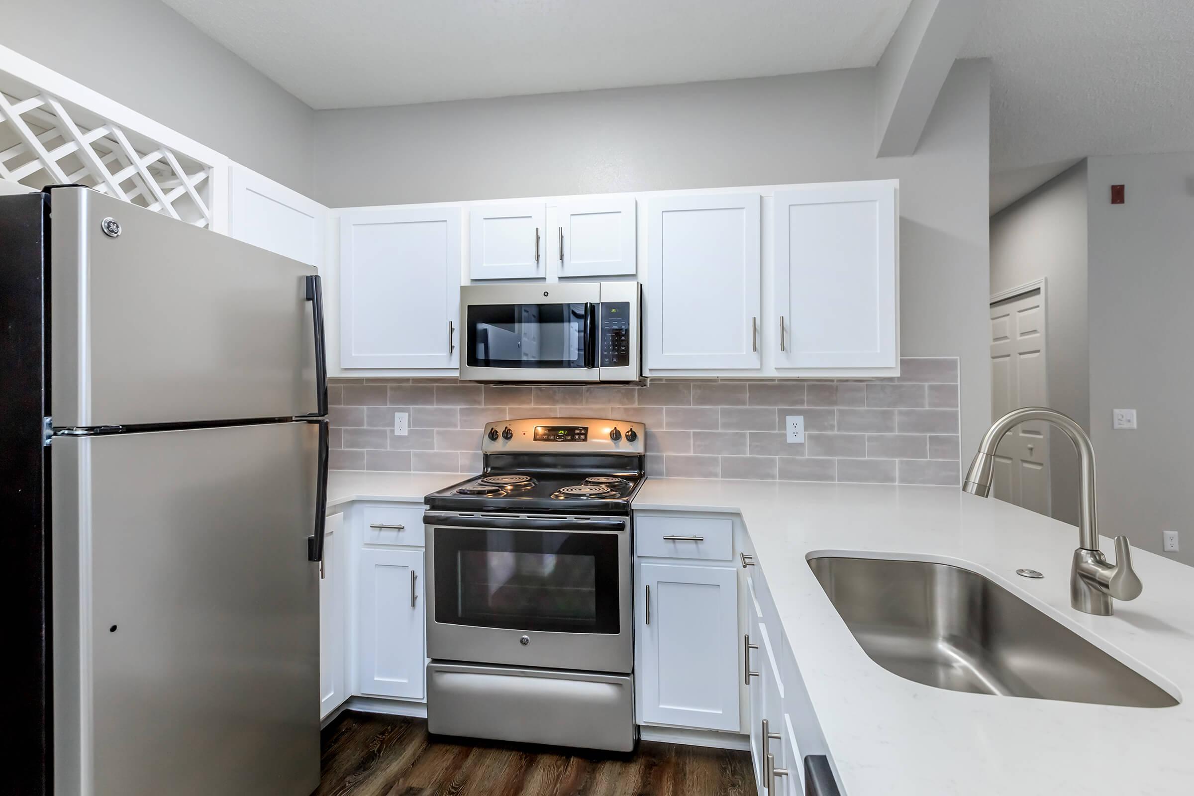 a stove top oven sitting inside of a kitchen