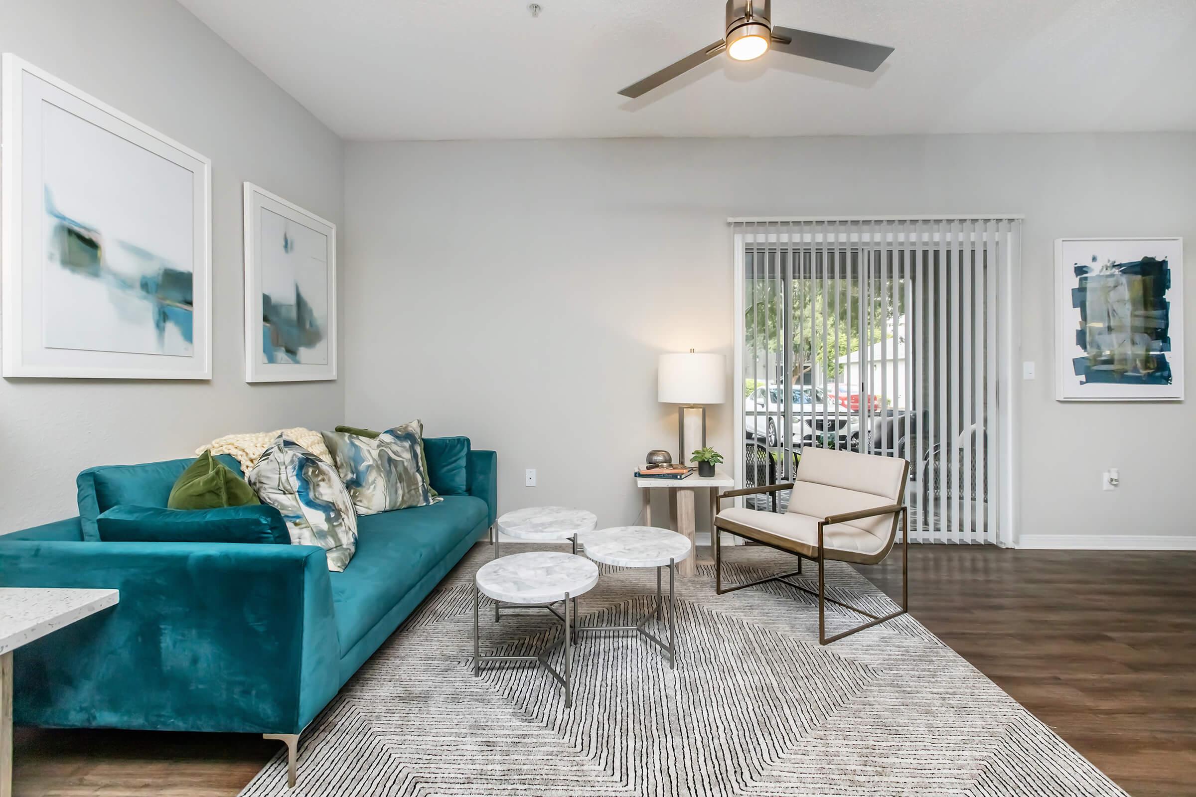 a living room filled with furniture and a large window