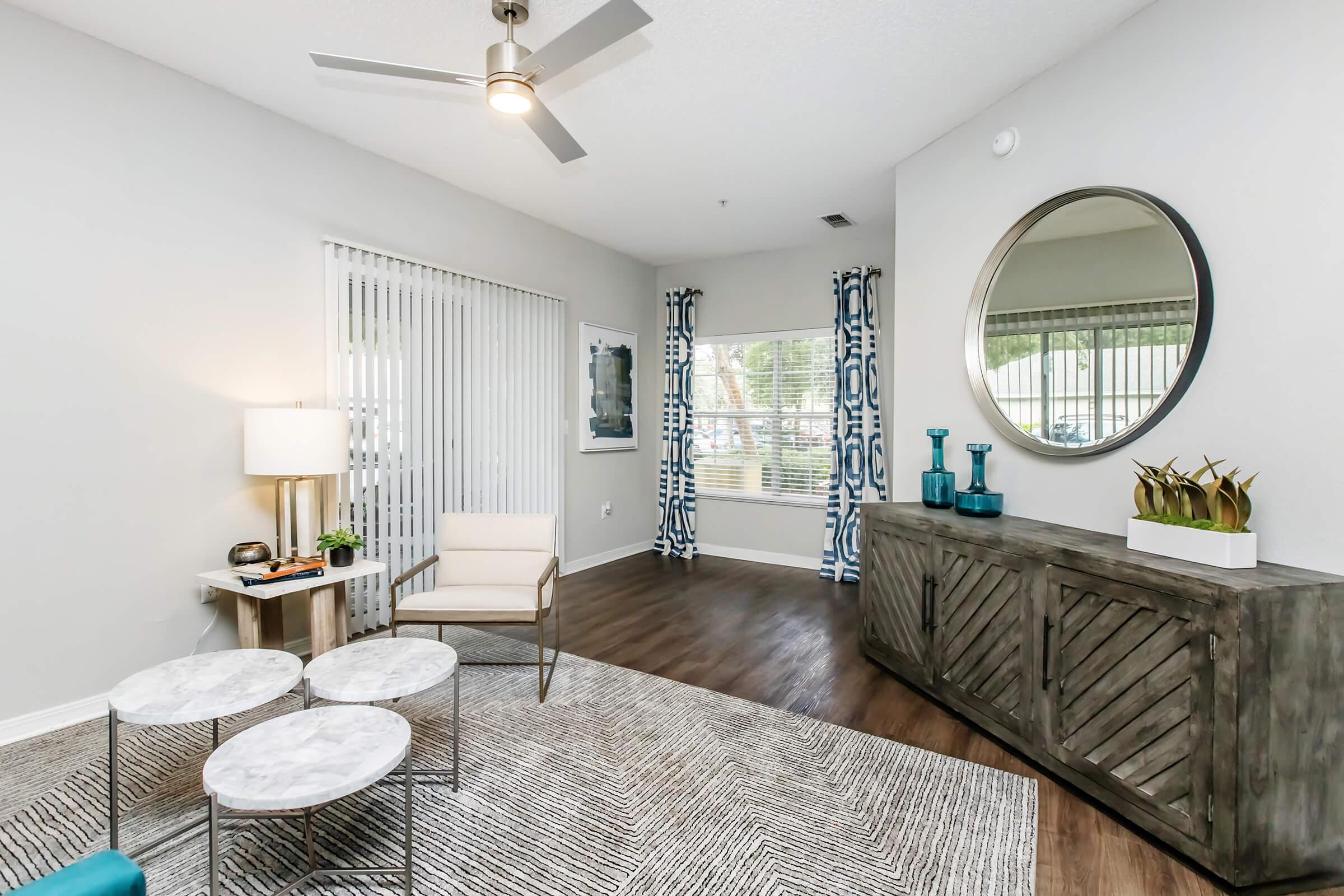 a living room filled with furniture and a large window