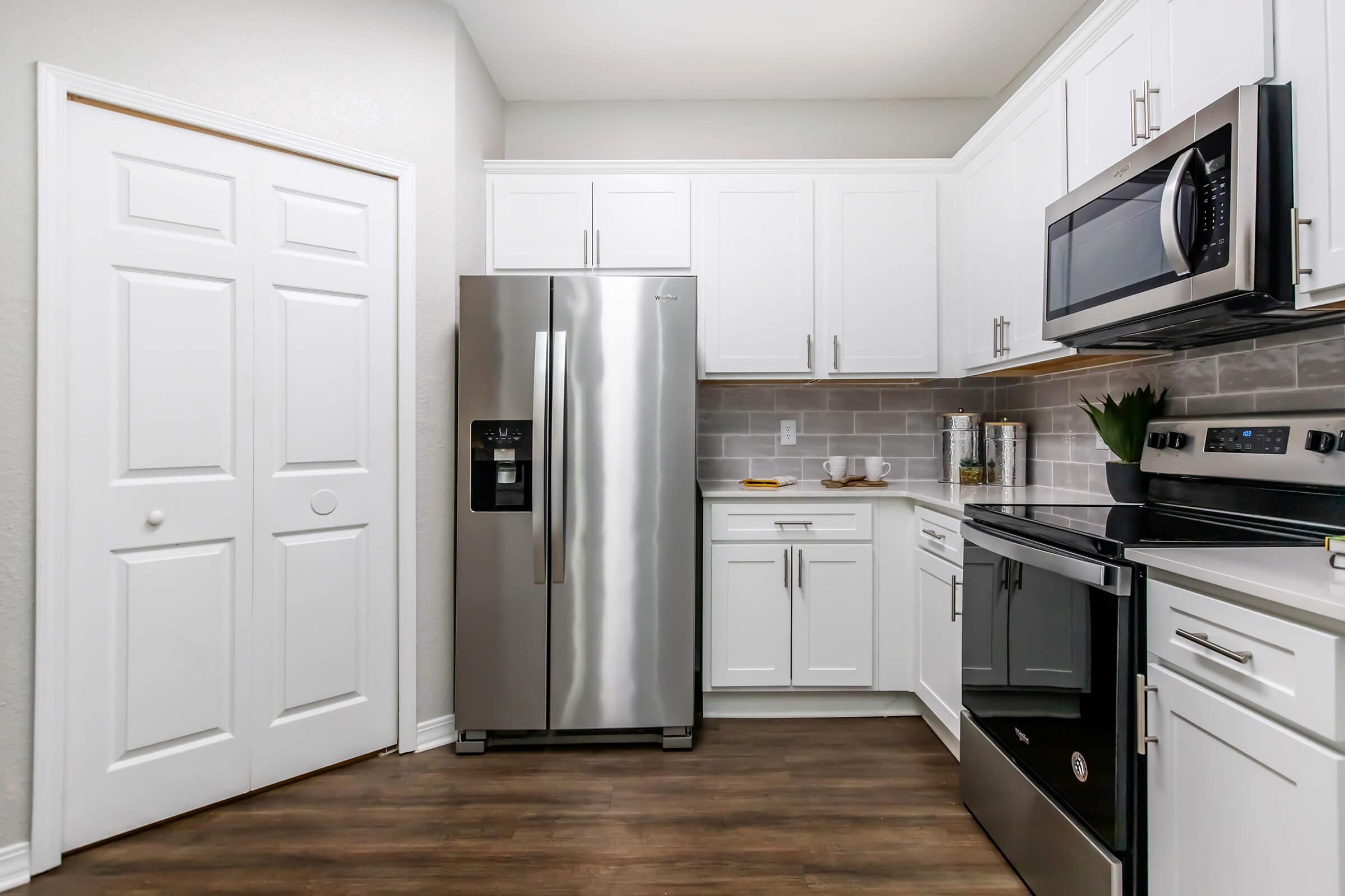 a kitchen with a stove and a refrigerator