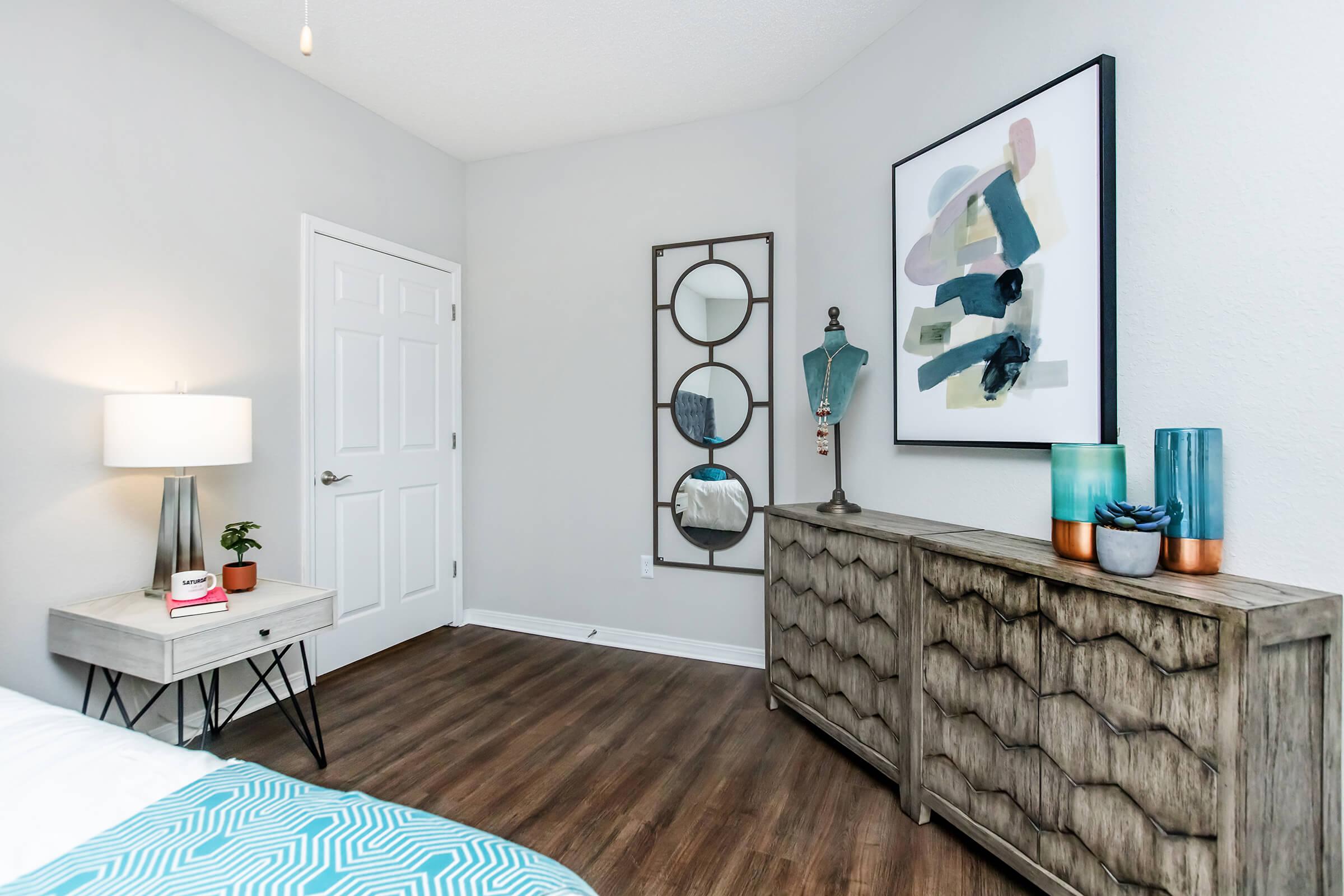 a bedroom with a bed and desk in a room