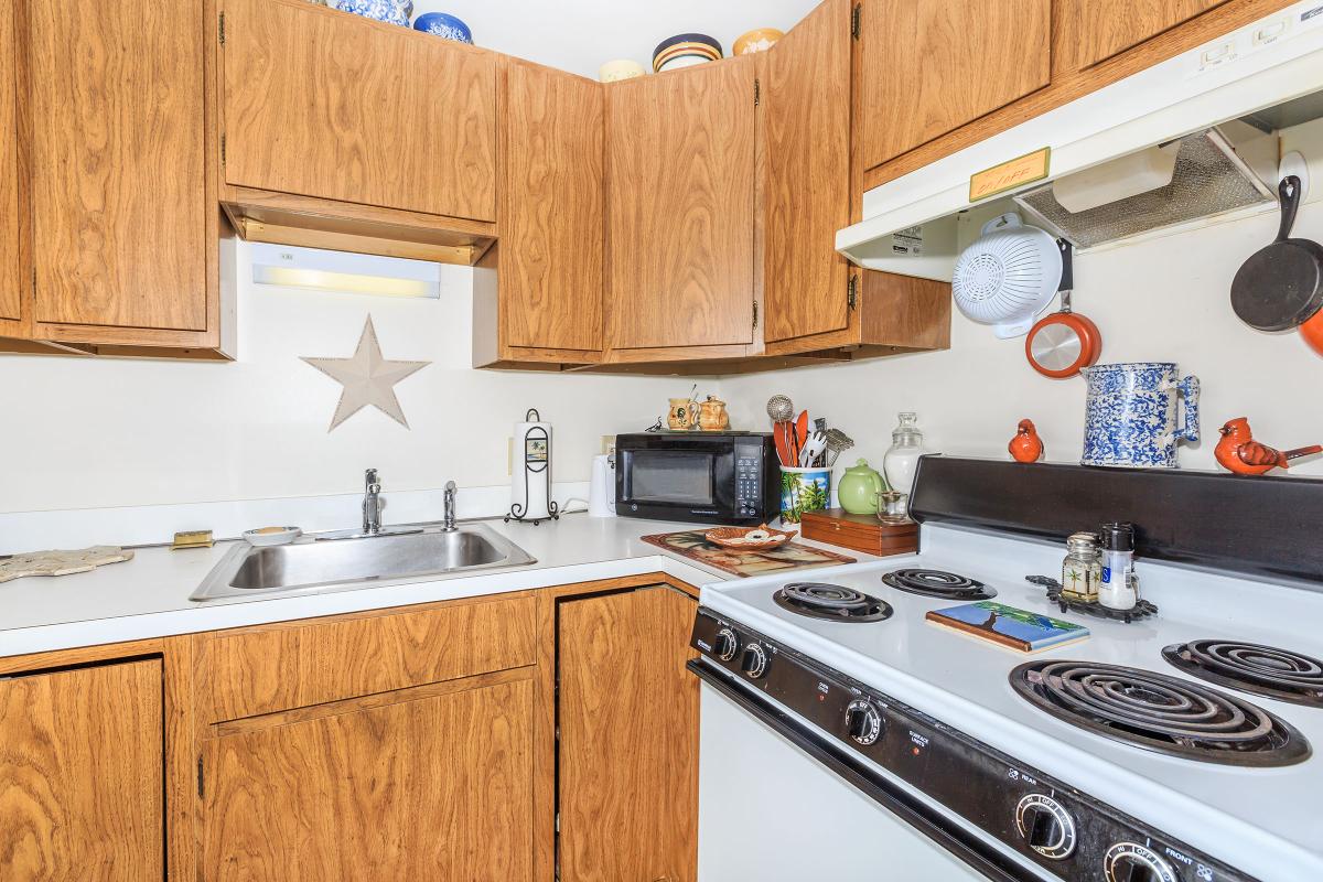 a kitchen with a stove a sink and a microwave