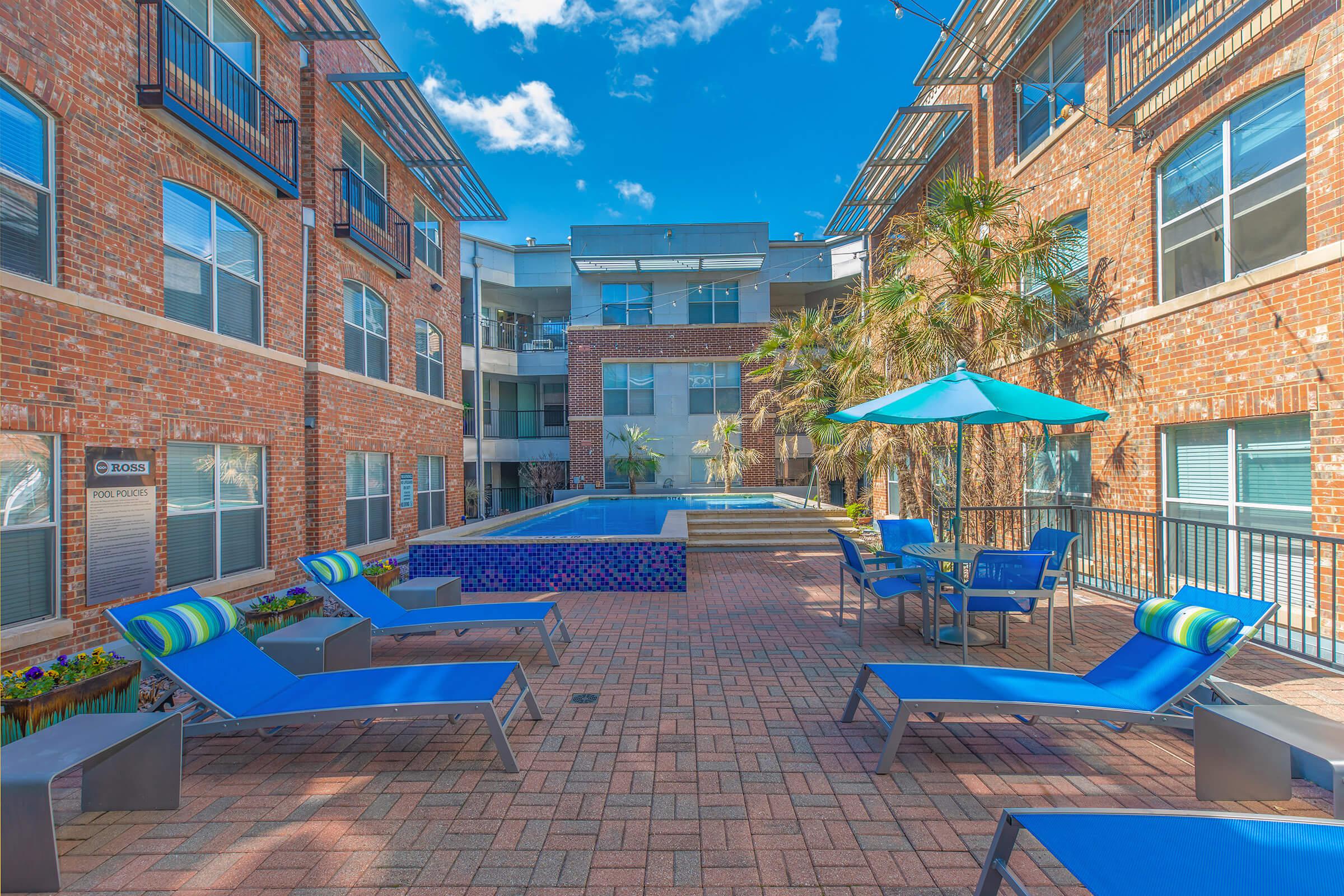 a blue bench in front of a brick building