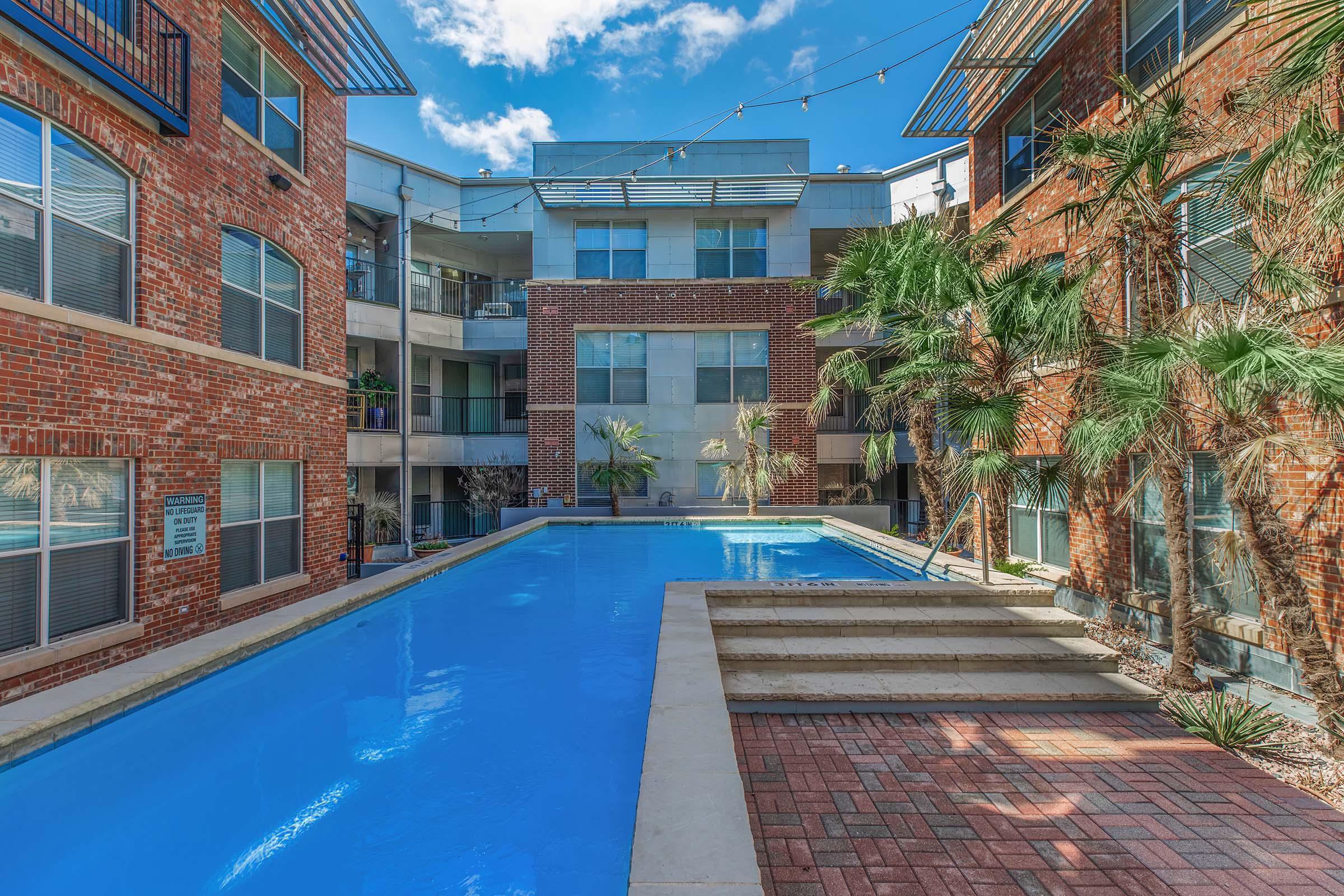 a large brick building with a pool