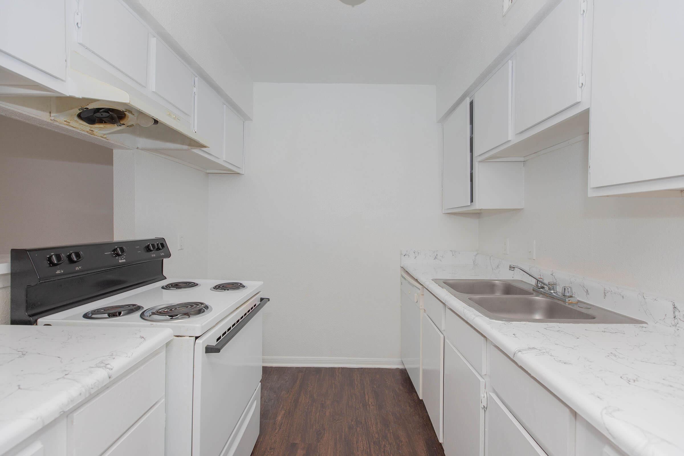 a kitchen with a stove and a sink