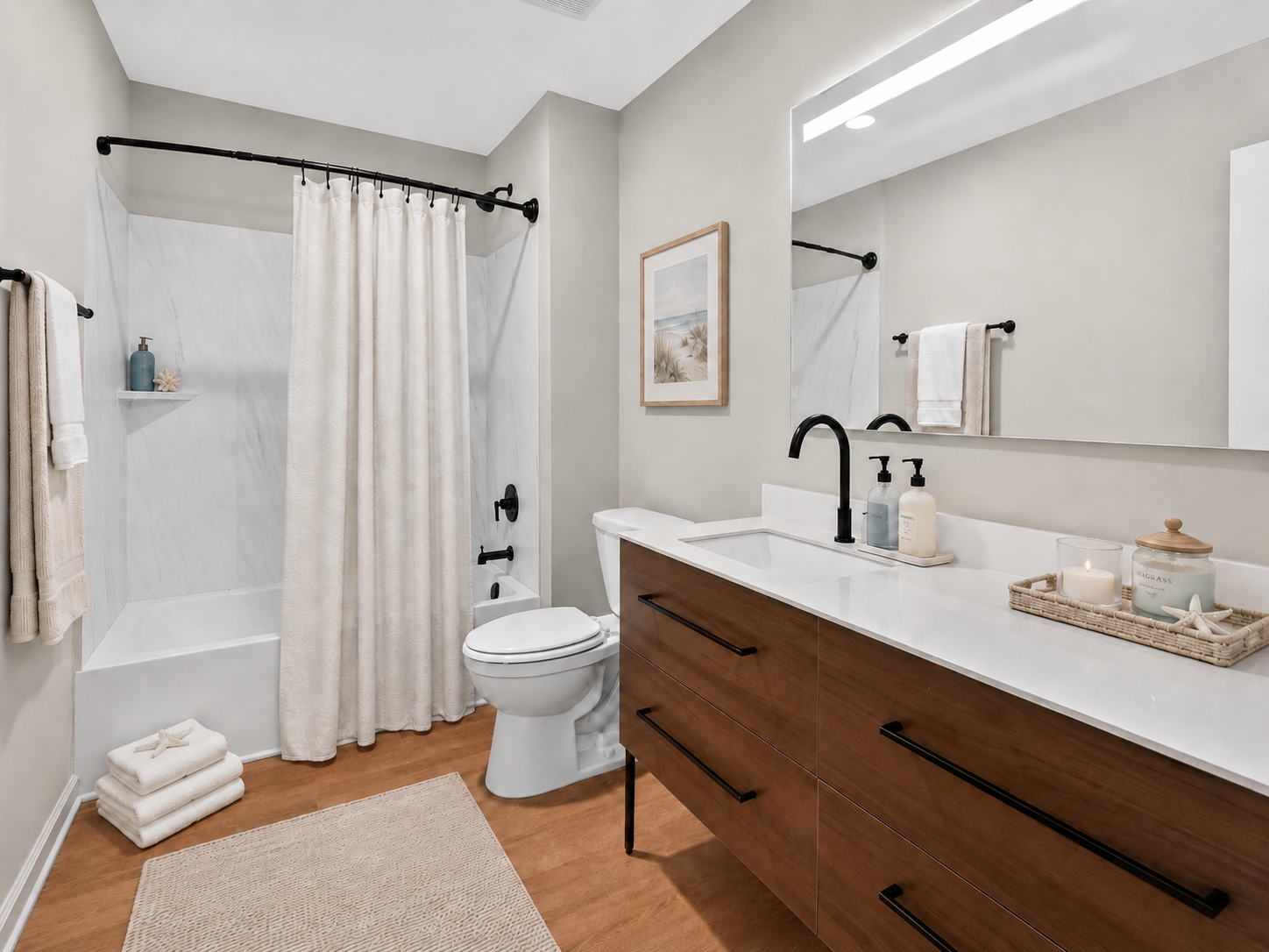 A modern bathroom featuring a bathtub with a beige shower curtain, a sleek white vanity with dark wood drawers, a large mirror, and decorative items on a tray. The room also has neutral-colored walls, a bath mat, and towels hanging, creating a clean and inviting atmosphere.