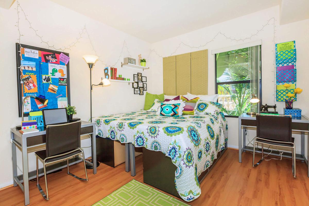 a living room filled with furniture on top of a hard wood floor