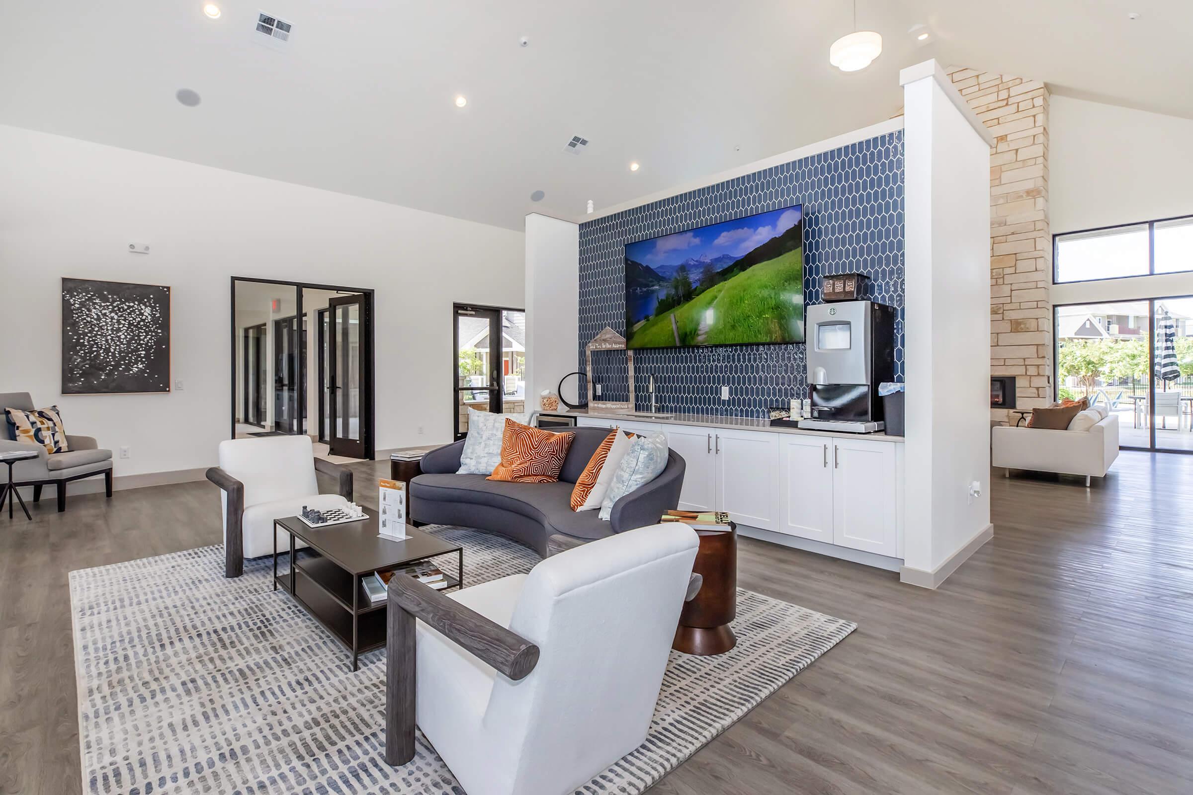 a living room filled with furniture and a large window