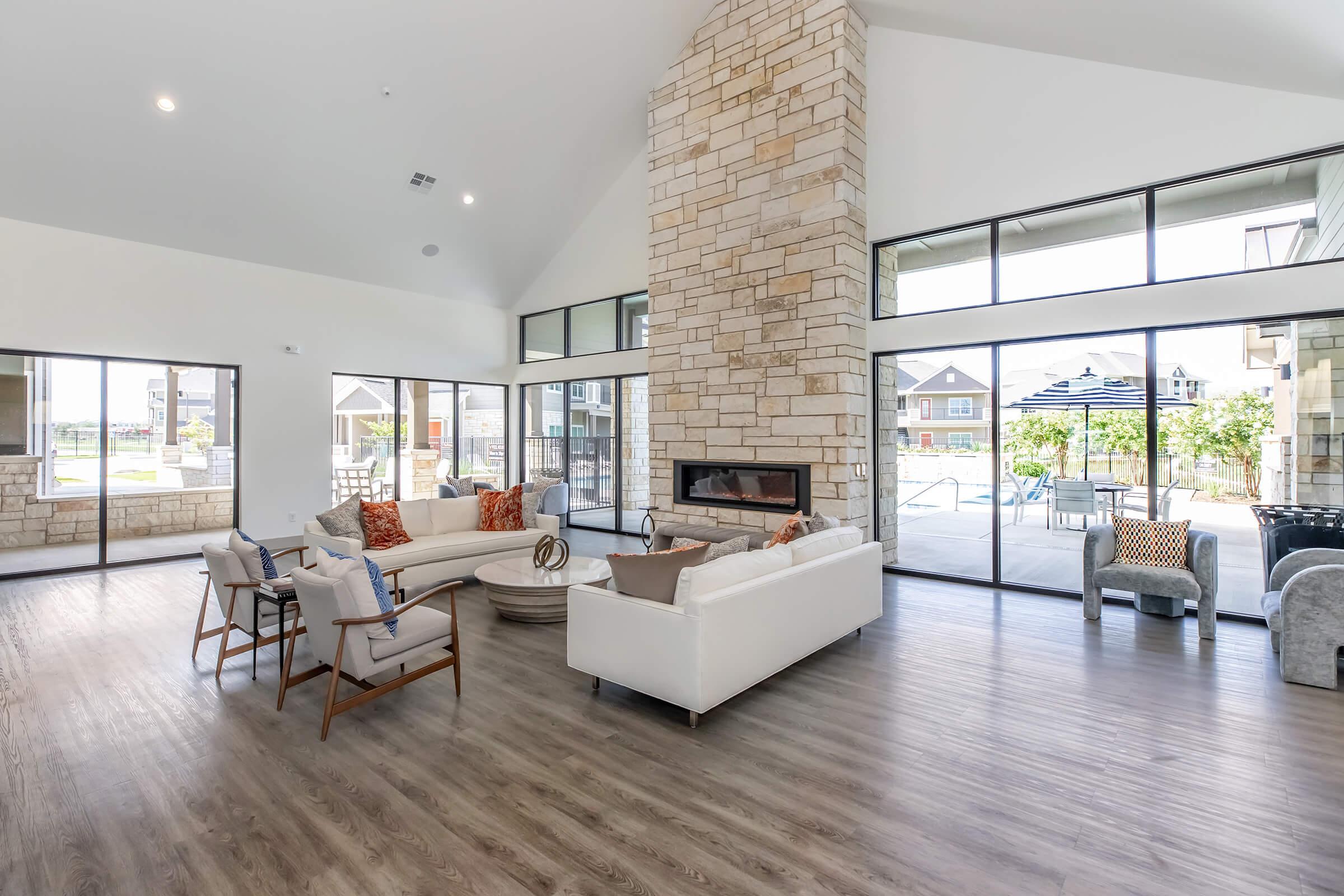 a living room filled with furniture and a large window