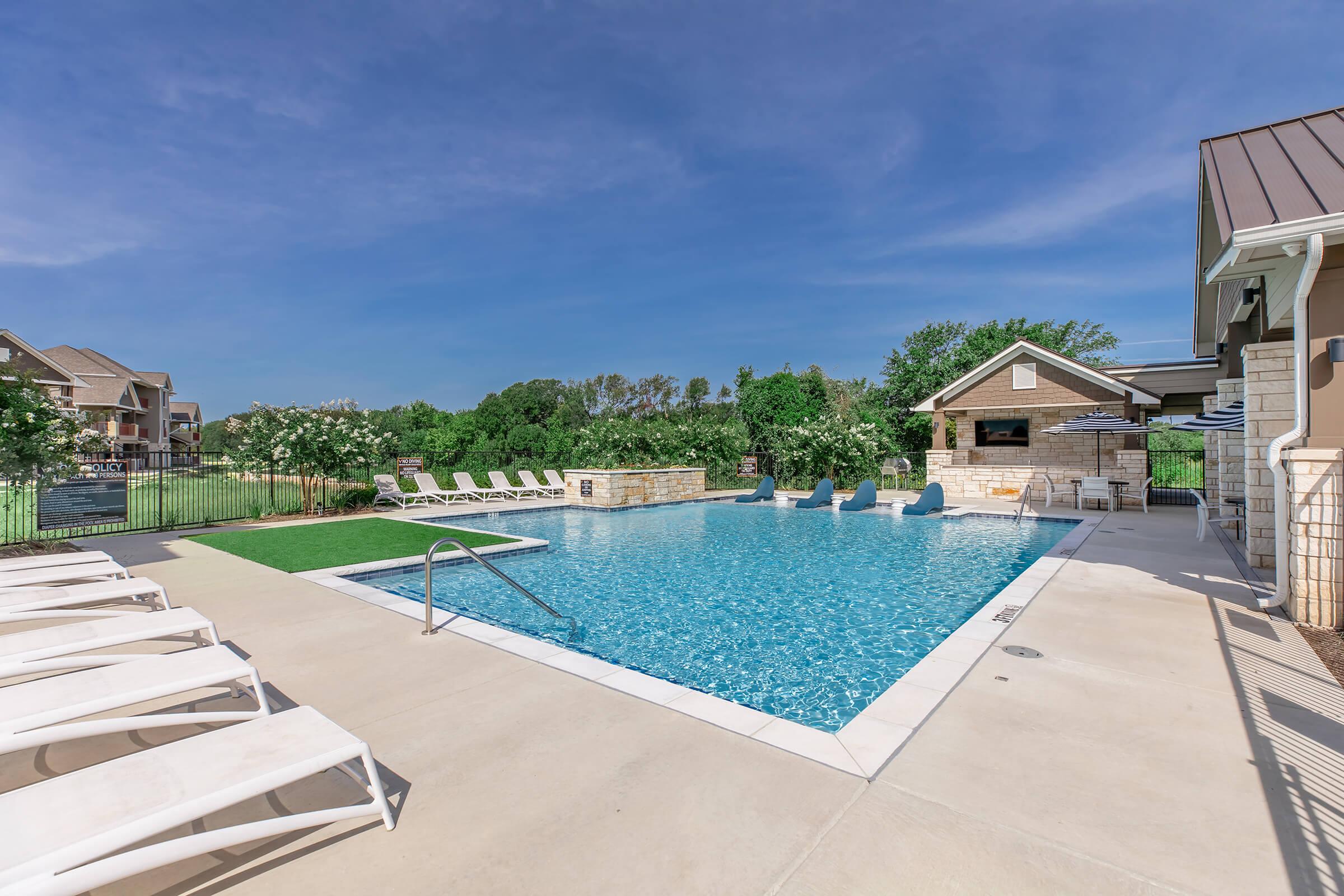 a house with a pool in front of a building