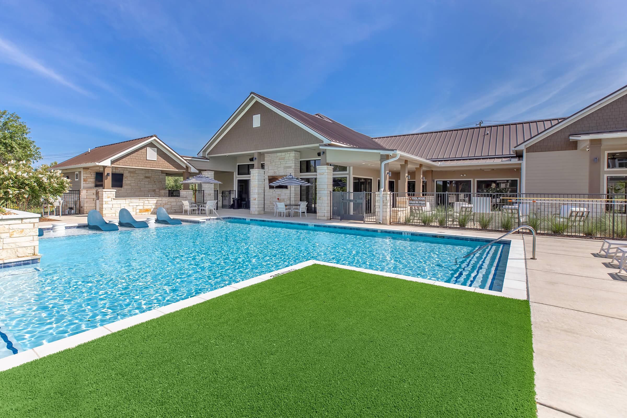 a house with a lawn in front of a building