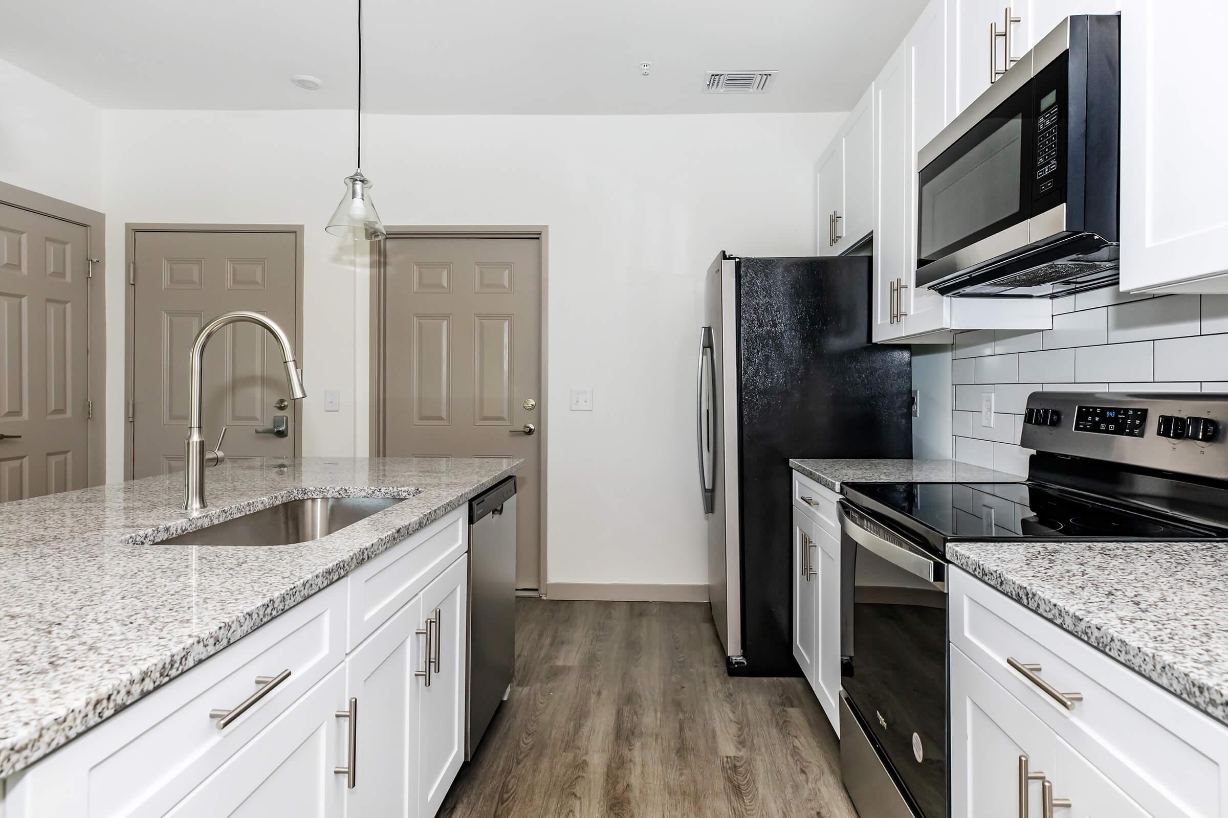 a kitchen with a sink and a microwave