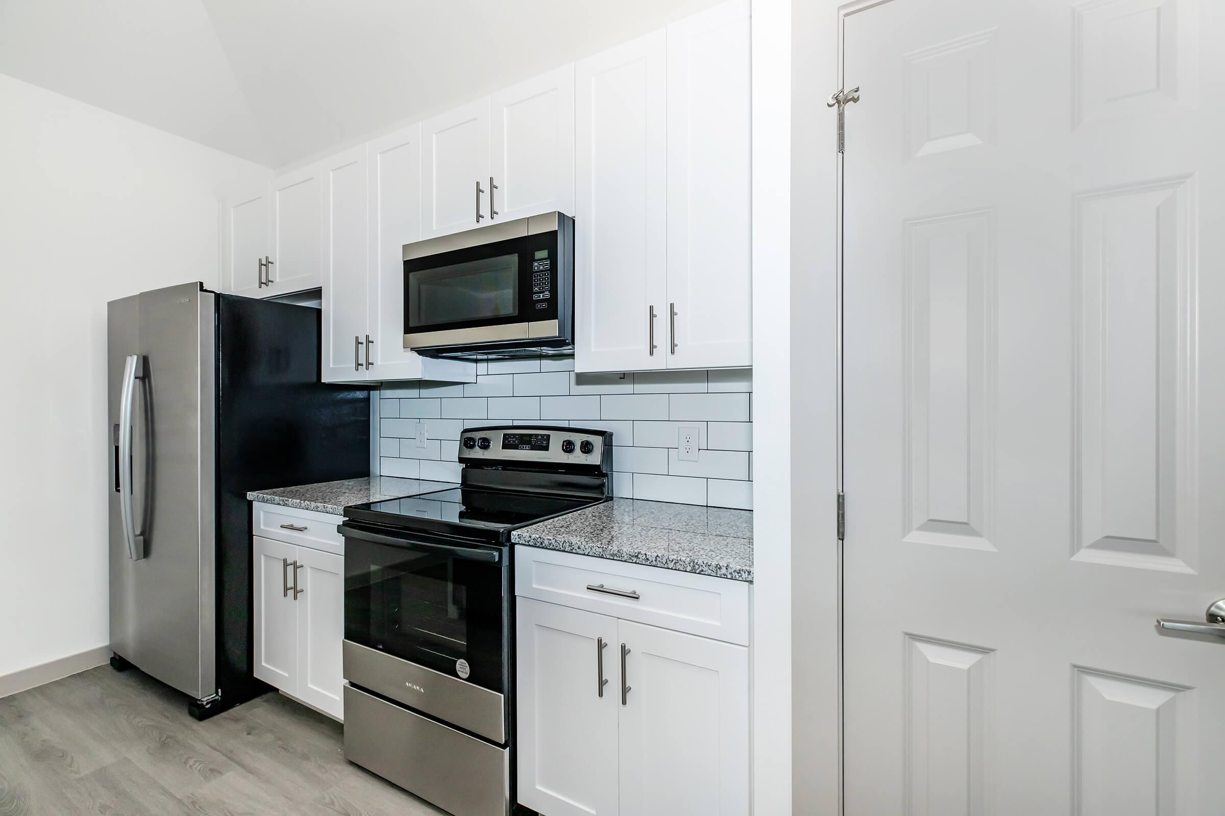 a kitchen with a stove and a refrigerator