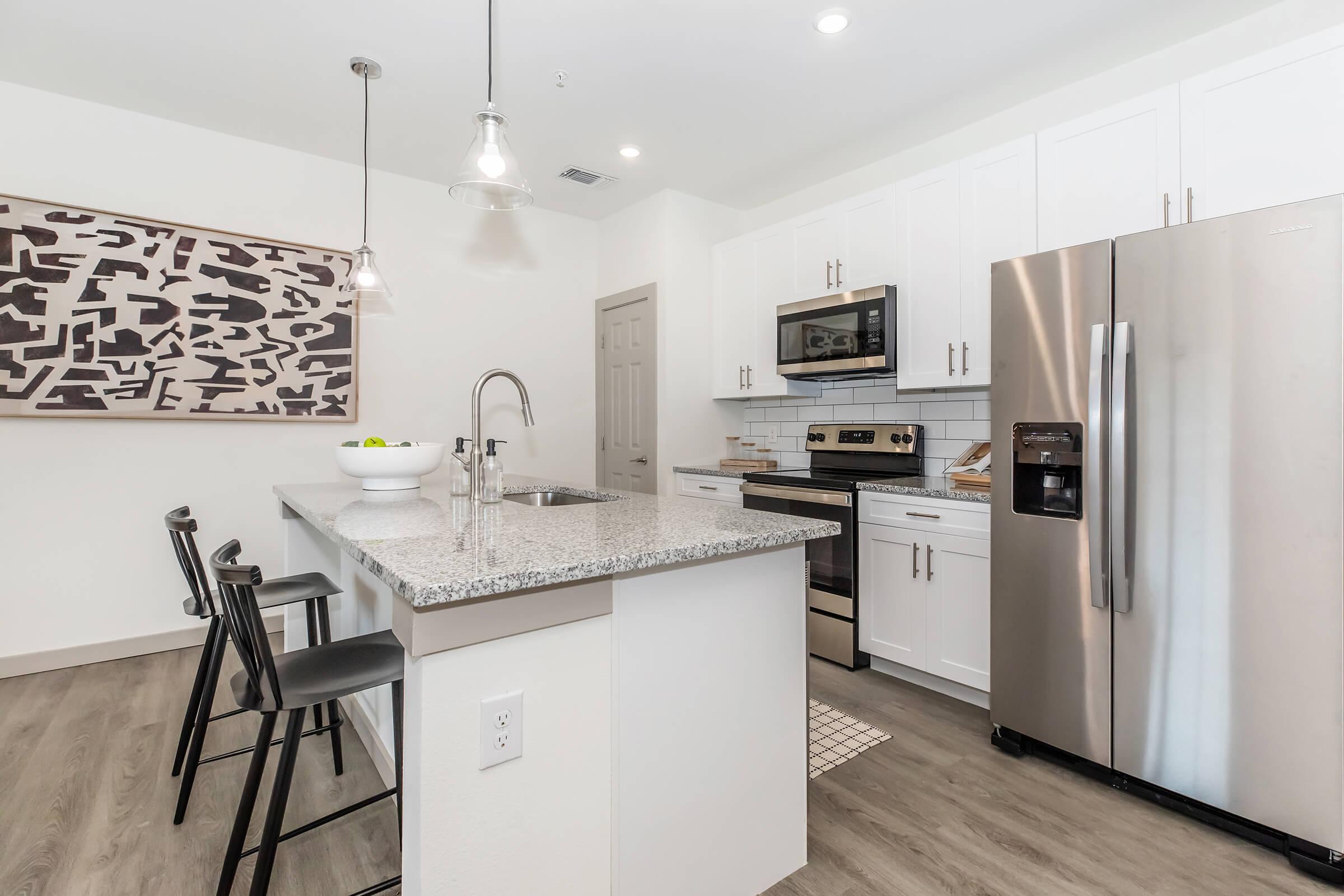 a kitchen with a sink and a refrigerator