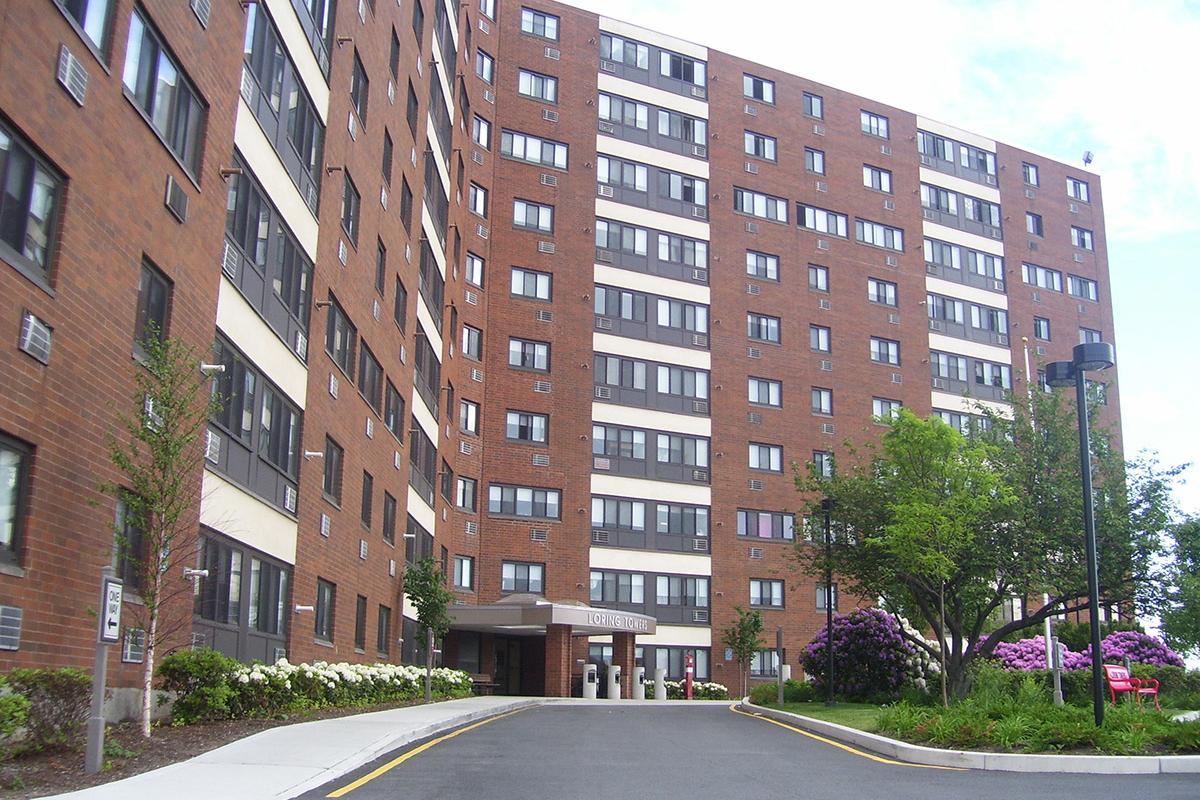 Community building with white and pink flowers