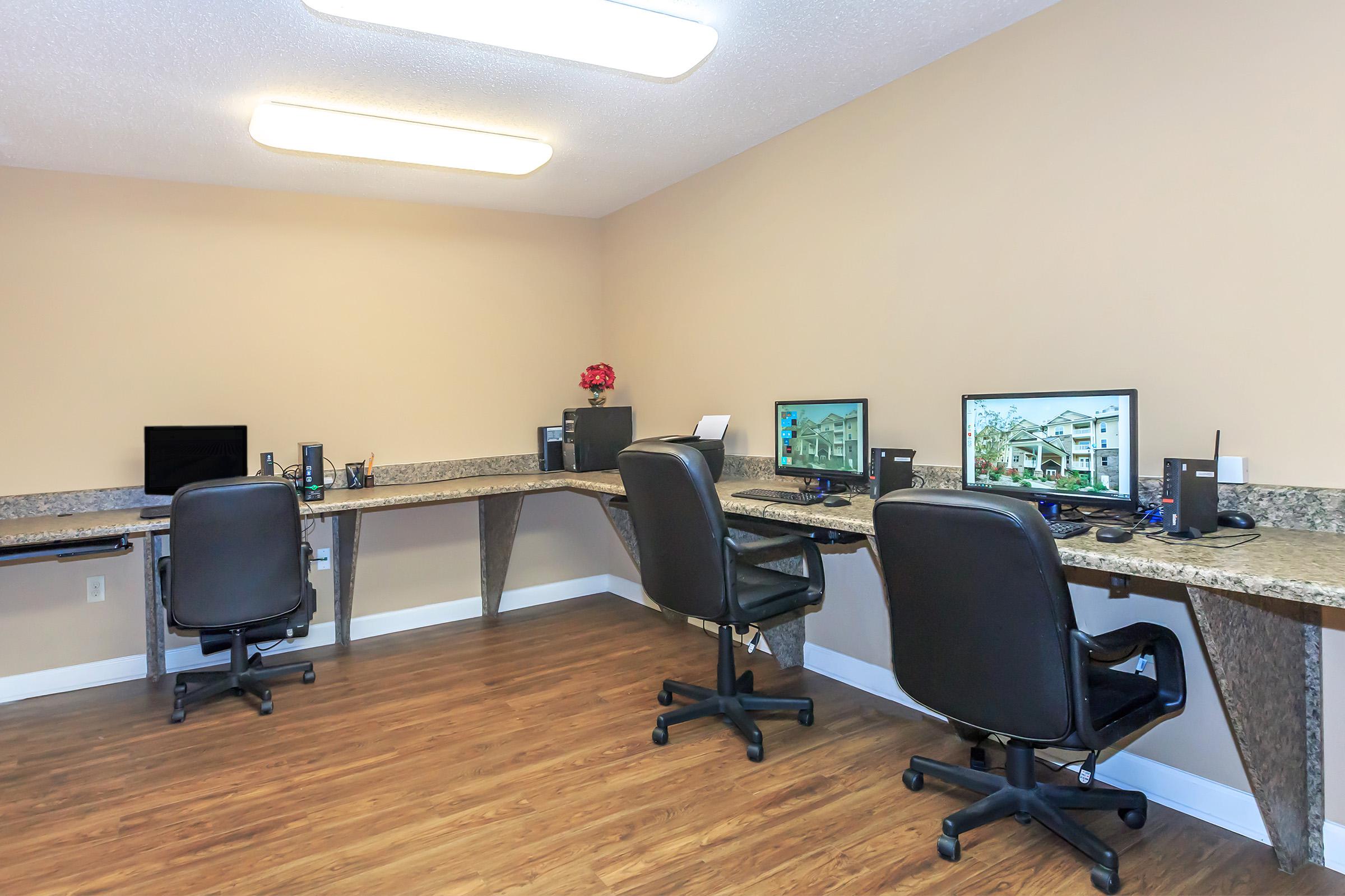 an office with a desk and chair in a room