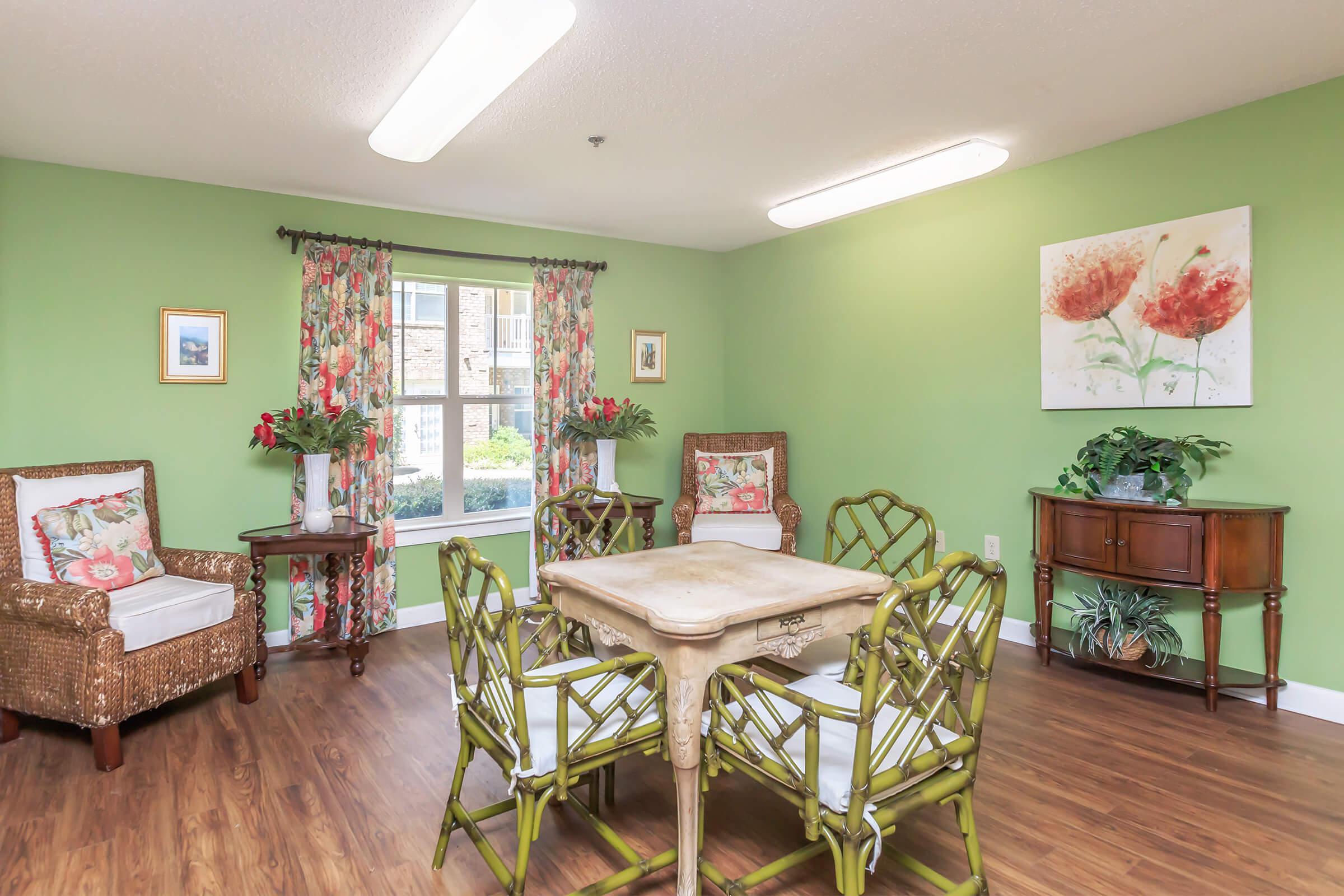 a living room filled with furniture on top of a wooden floor