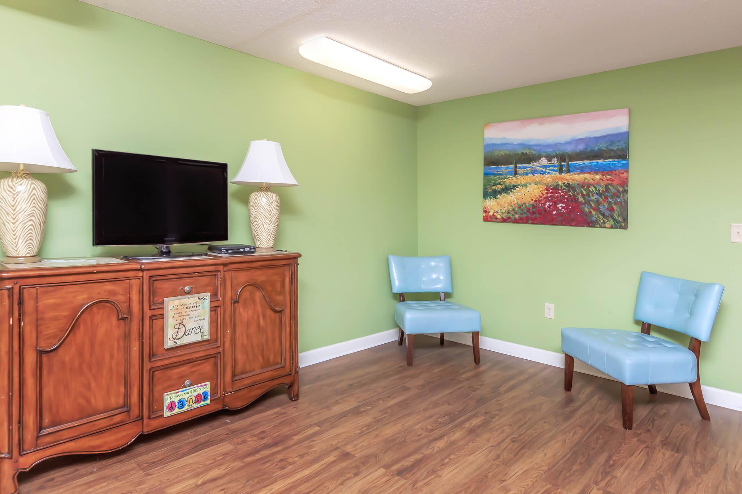 a living room filled with furniture and a wood floor