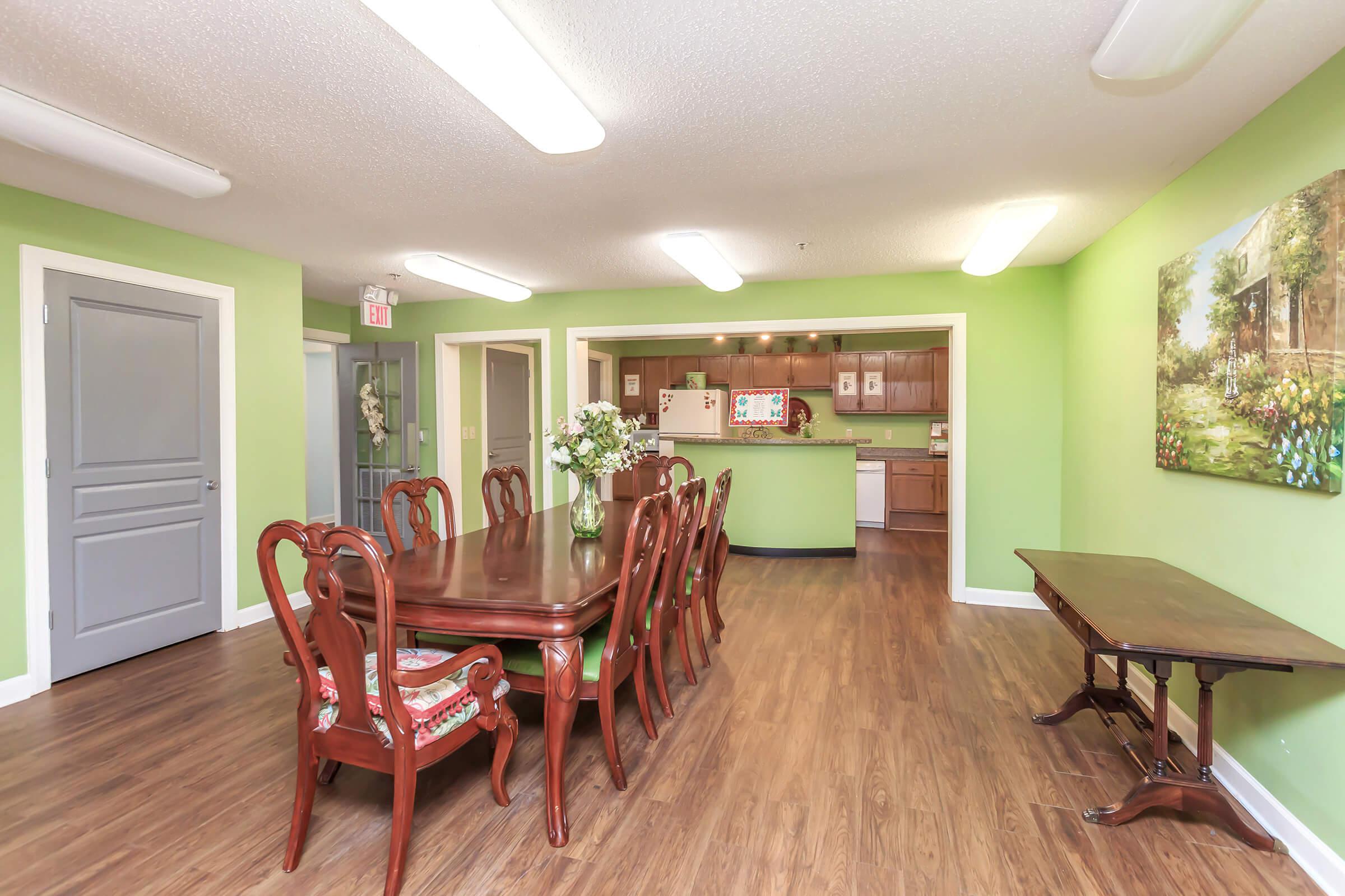 a living room filled with furniture on top of a hard wood floor