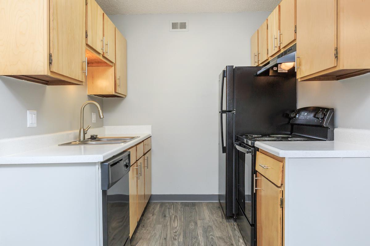 a kitchen with a sink and a refrigerator