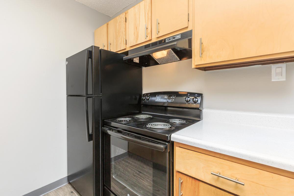 a stove top oven sitting inside of a kitchen