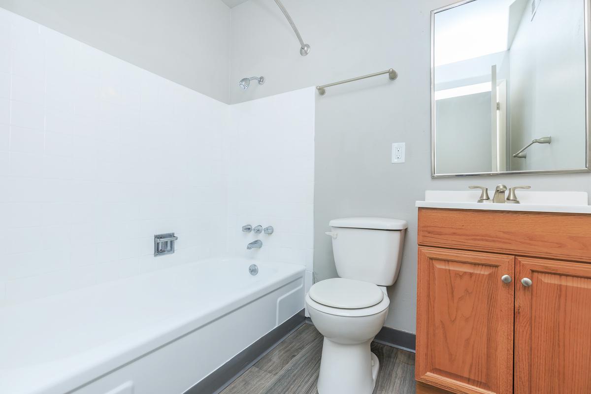 a white sink sitting next to a shower