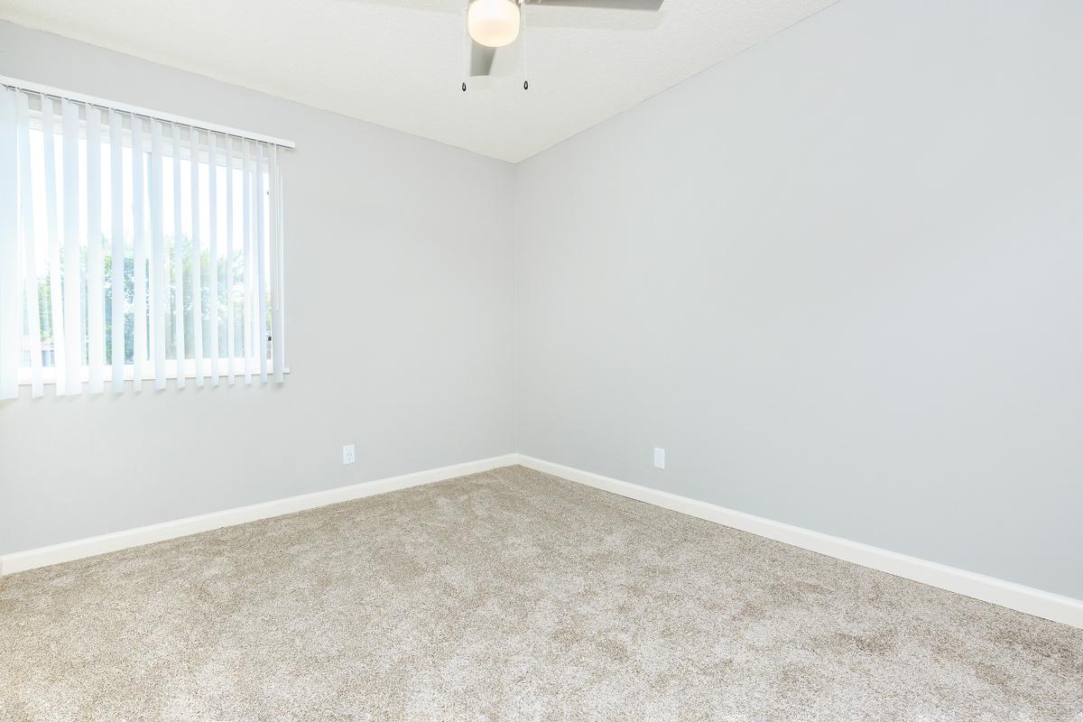 a bedroom with a large mirror