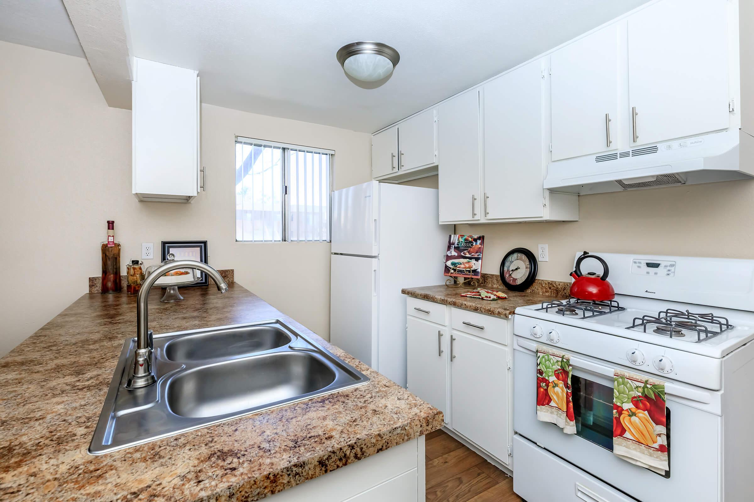 a kitchen with a sink and a refrigerator