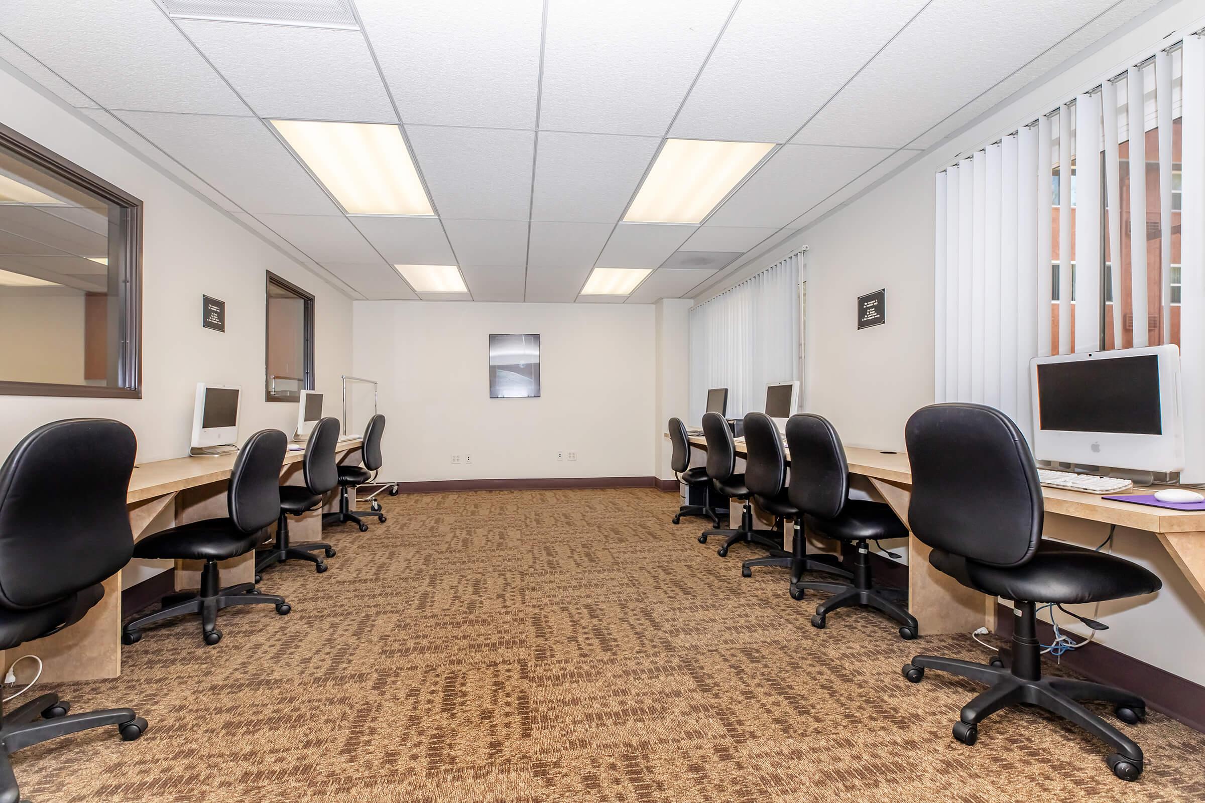 an office with a desk and chair in a room